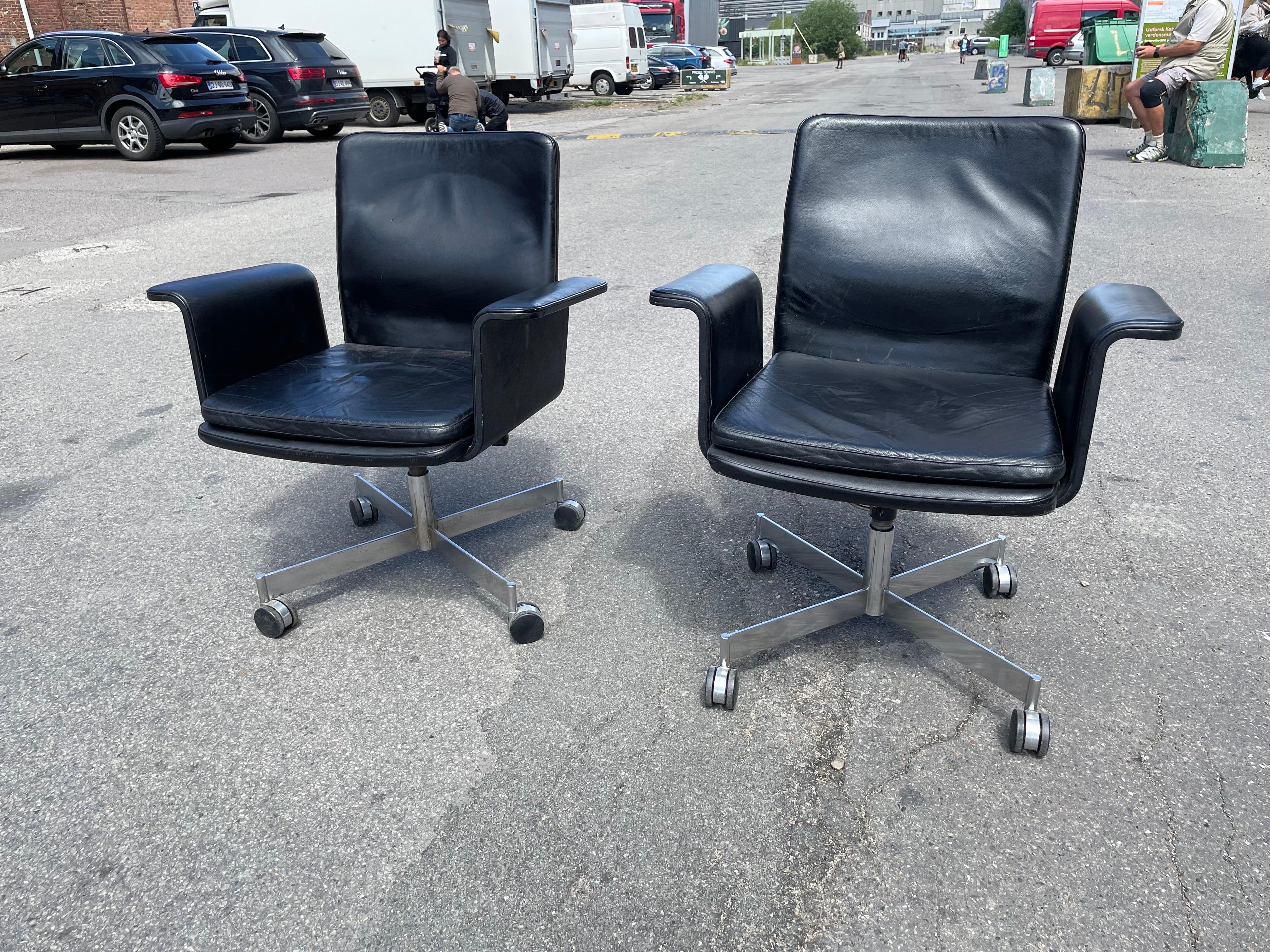 Two Swivel chairs in patinated leather on a swivel base. Designed by the renowned Jørgen Rasmussen for Kevi A/S in the 1960s and proudly made in Denmark, these chairs are in a good original condition.