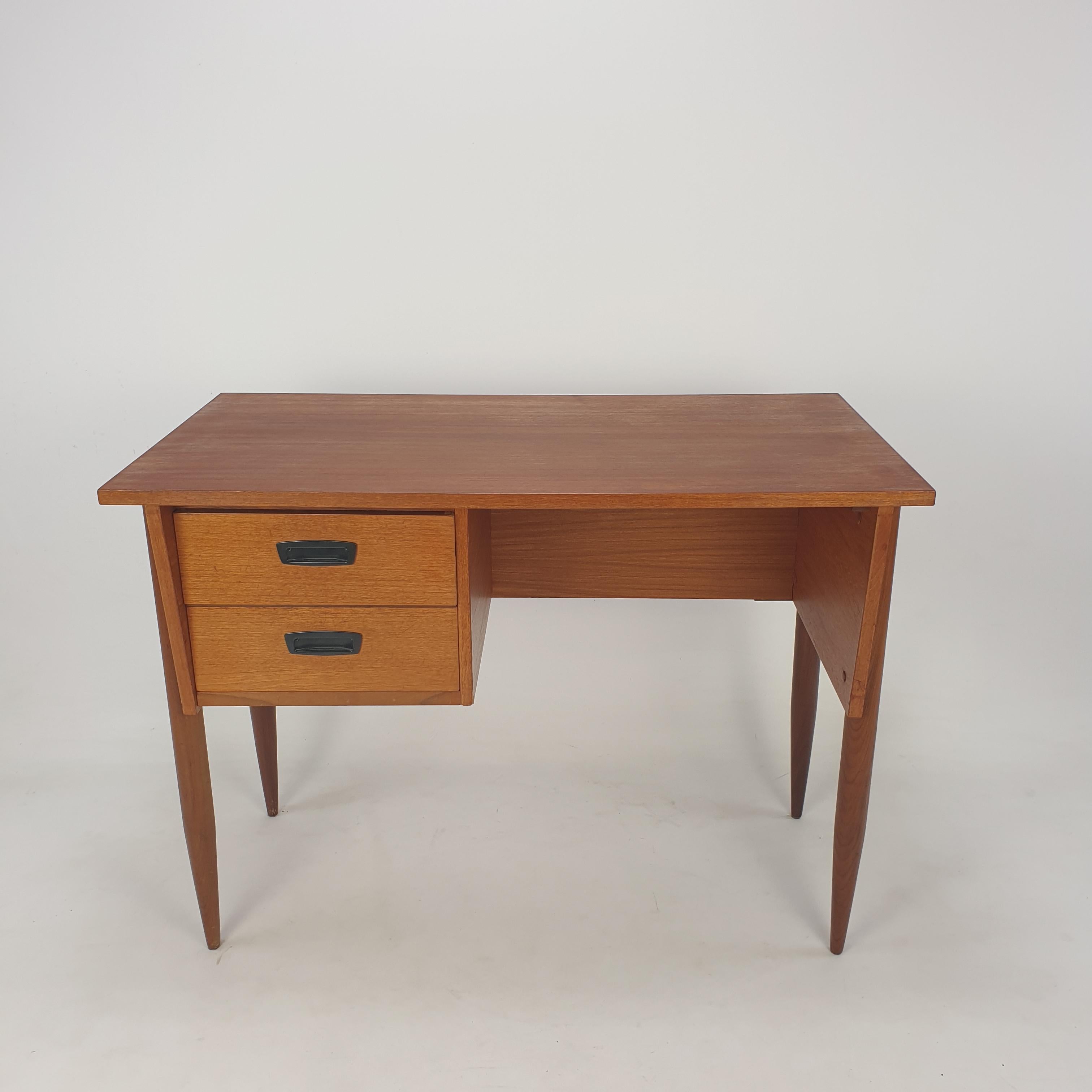 Very nice mid century Danish teak desk. 
It is fabricated in the 60's.

Two drawers with the original bakelite handles.

This desk is in great vintage condition.
  