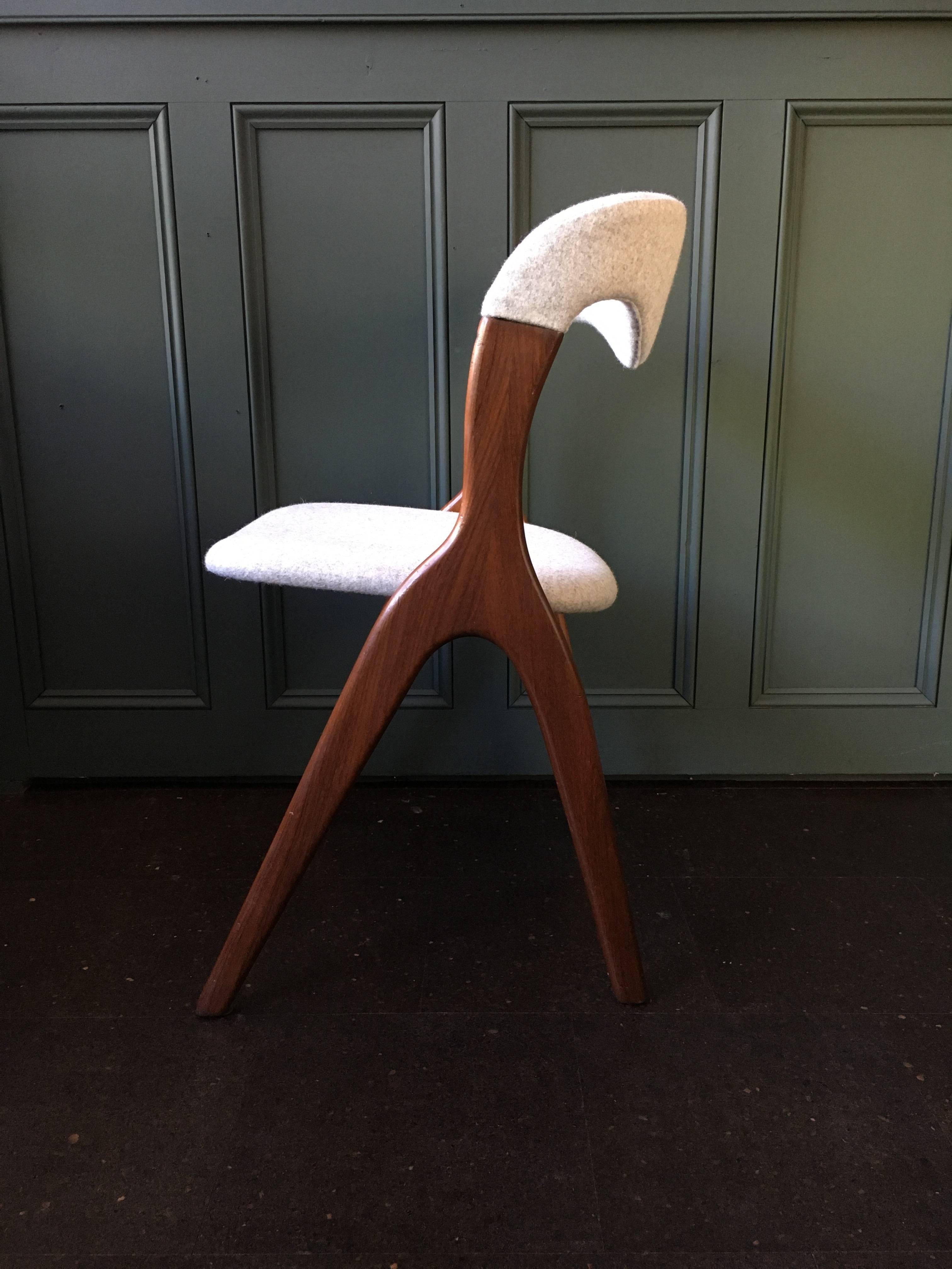 Set of eight, fully repolished and reupholstered dining chairs. Highly unusual and very distinctive design from the 1960s, Denmark. Solid dark teak frame with new light grey felt upholstery. We can change the fabric if another colour is