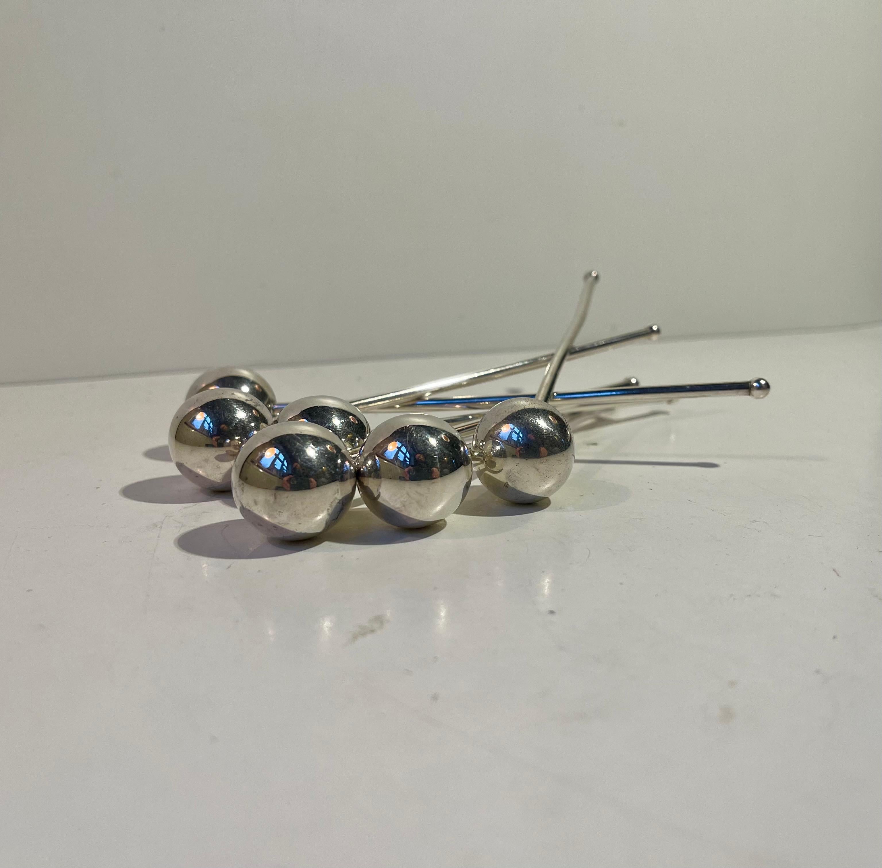 A set of 6 drink coolers or stirrers. Composed of silver plated brass. Molecular perceived/inspired design features. Designed of manufactured by ABSA in Denmark in a style reminiscent of Piet Hein. 

Measurements: L/H: 16.5 cm, Diameter: 3.5 cm.