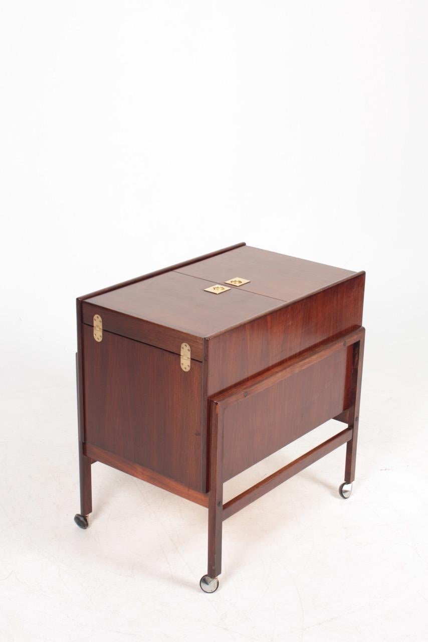 Midcentury modern dry bar in rosewood. It is designed and made Dyrlund in Denmark.