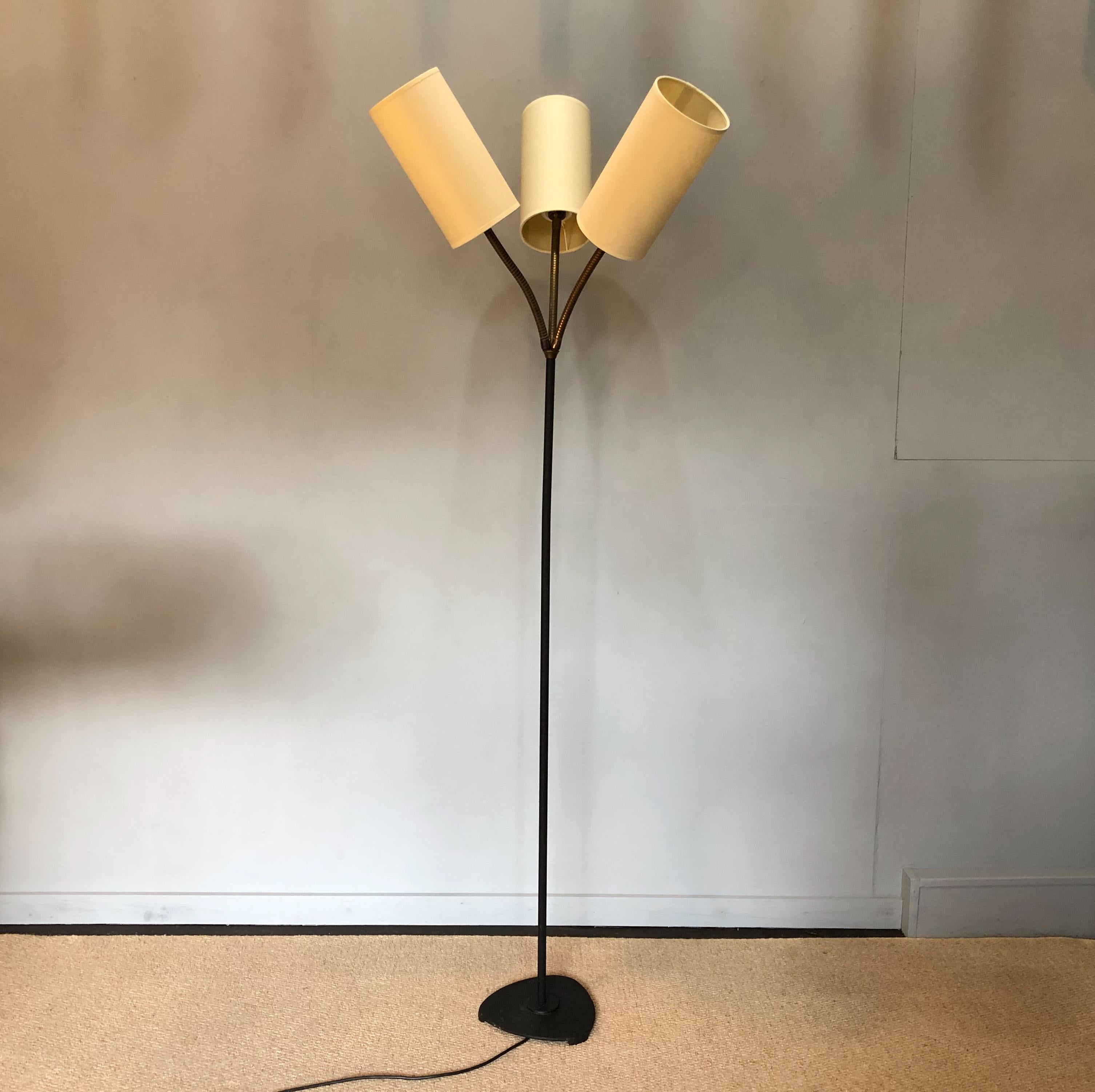 A Danish midcentury floor lamp, circa 1950. Black steel with brass triple head goose neck stems. New parchment cylinder shades. Fully rewired.