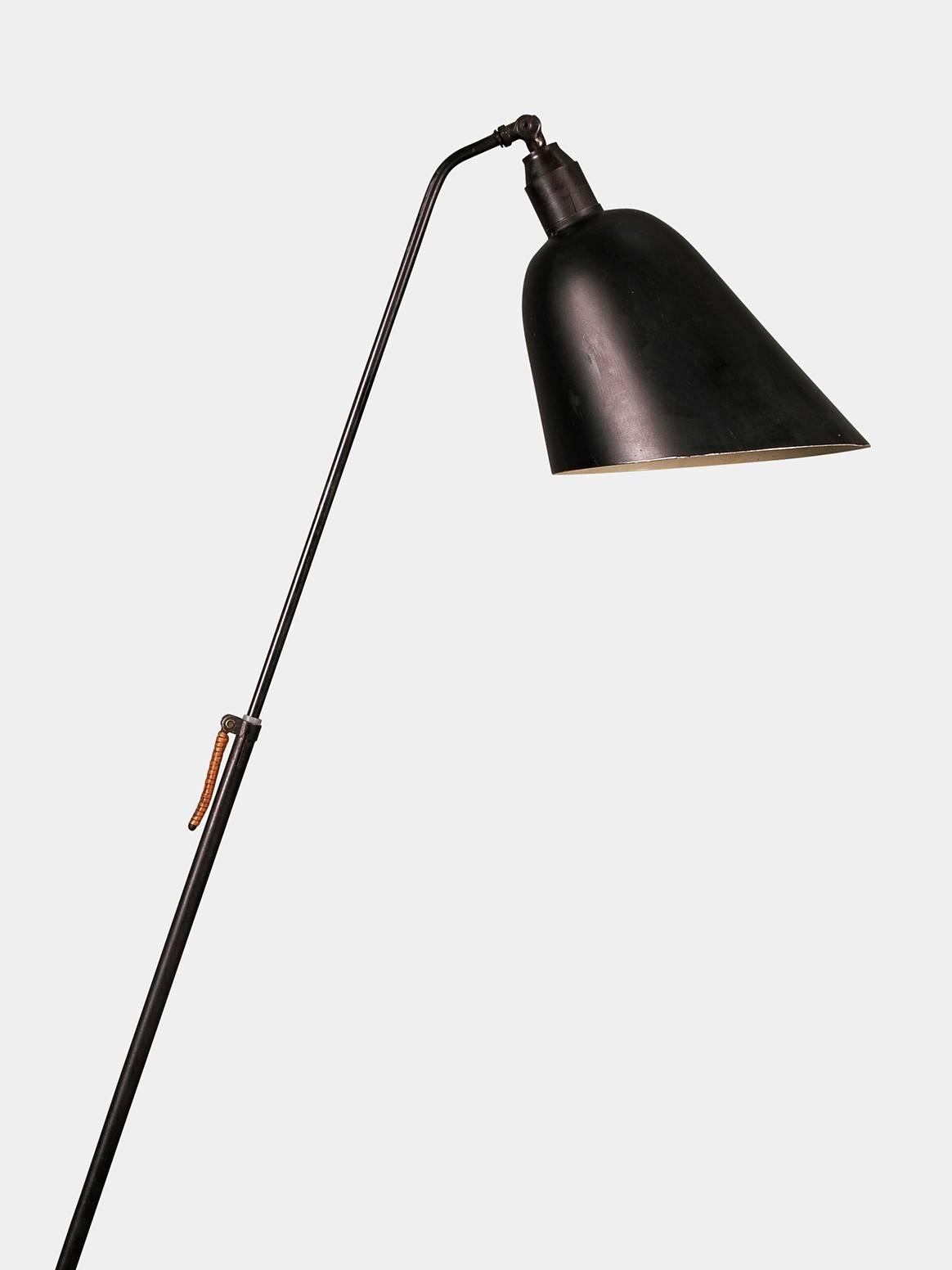 Danish floor lamp from the midcentury - original and in a beautiful condition. 

Black lacquered shade and stand with woven cane details and adjustable height. 

Designed and manufactured in the 1950s. 

 