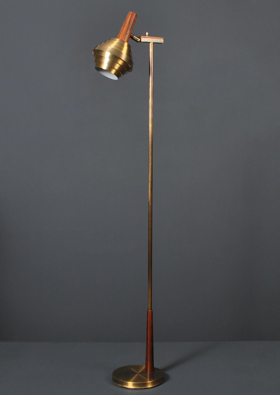Unusual brass Danish midcentury floor lamp. Circa 1960. Adjustable head with top surface on/off button.
 
