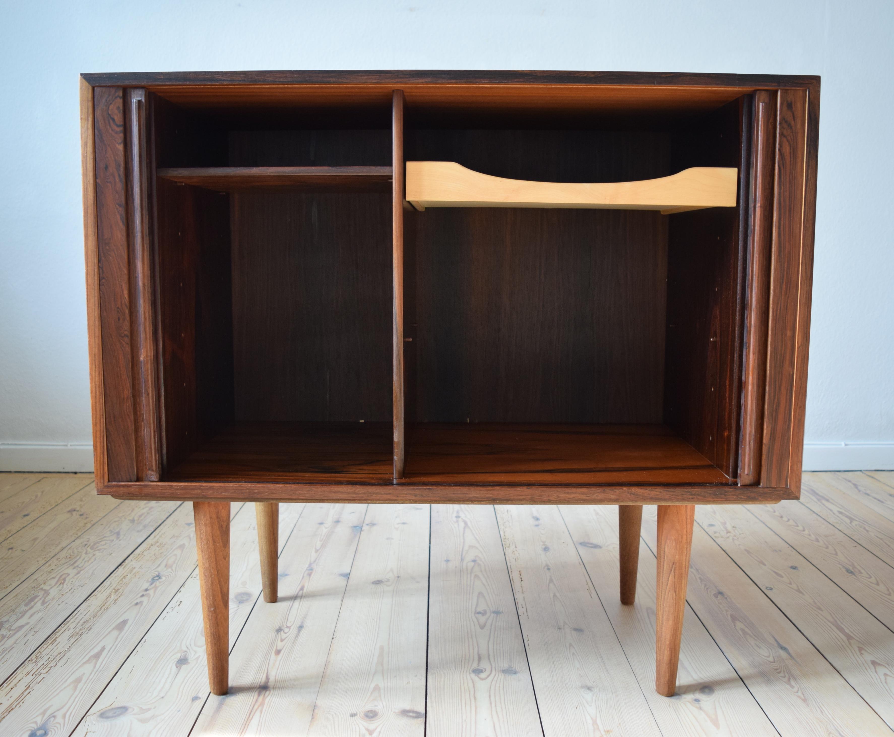 Danish rosewood cabinet by Kai Kristiansen for FM Møbler. Manufactured in the 1960s, this piece features two tambour doors with internal compartment with shelf on the left side and felt lined maple drawer on the right side. Striking rosewood grain