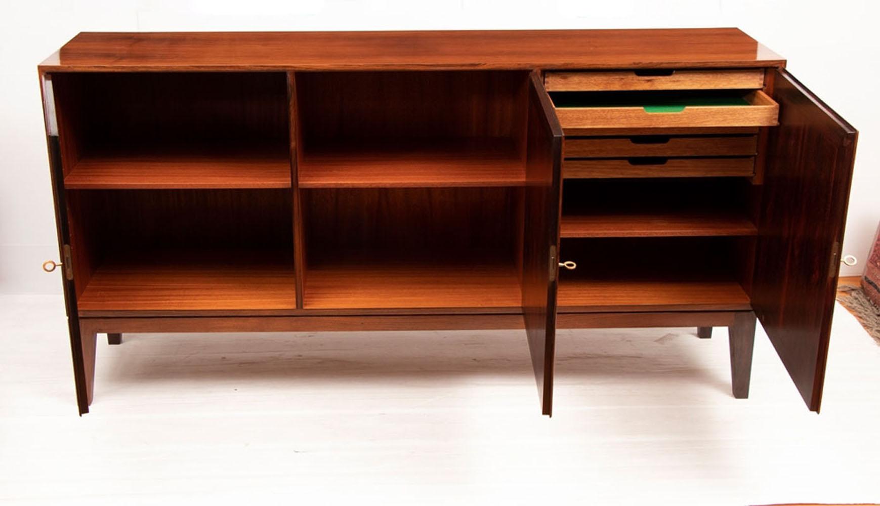 Danish midcentury Kai Winding sideboard by Poul Jeppesen, circa 1960.
This sideboard has been polished and is imaculate as per the photos. It is absolutely beautiful.

A Classic design by Poul Jeppesen, circa 1960.