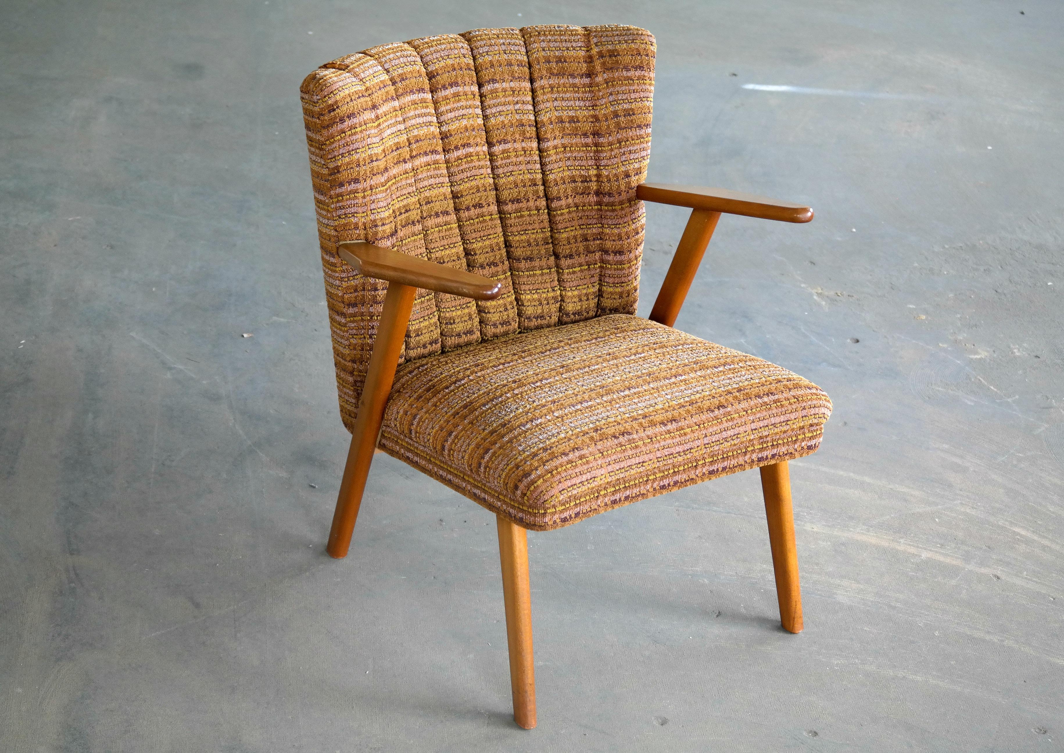 Nice light and smaller size cocktail or easy chair in the style of Kurt Olsen. Great for a smaller room where space is an issue and you may want to be able to move the chair around. The frame and armrest are made of beech wood and the original