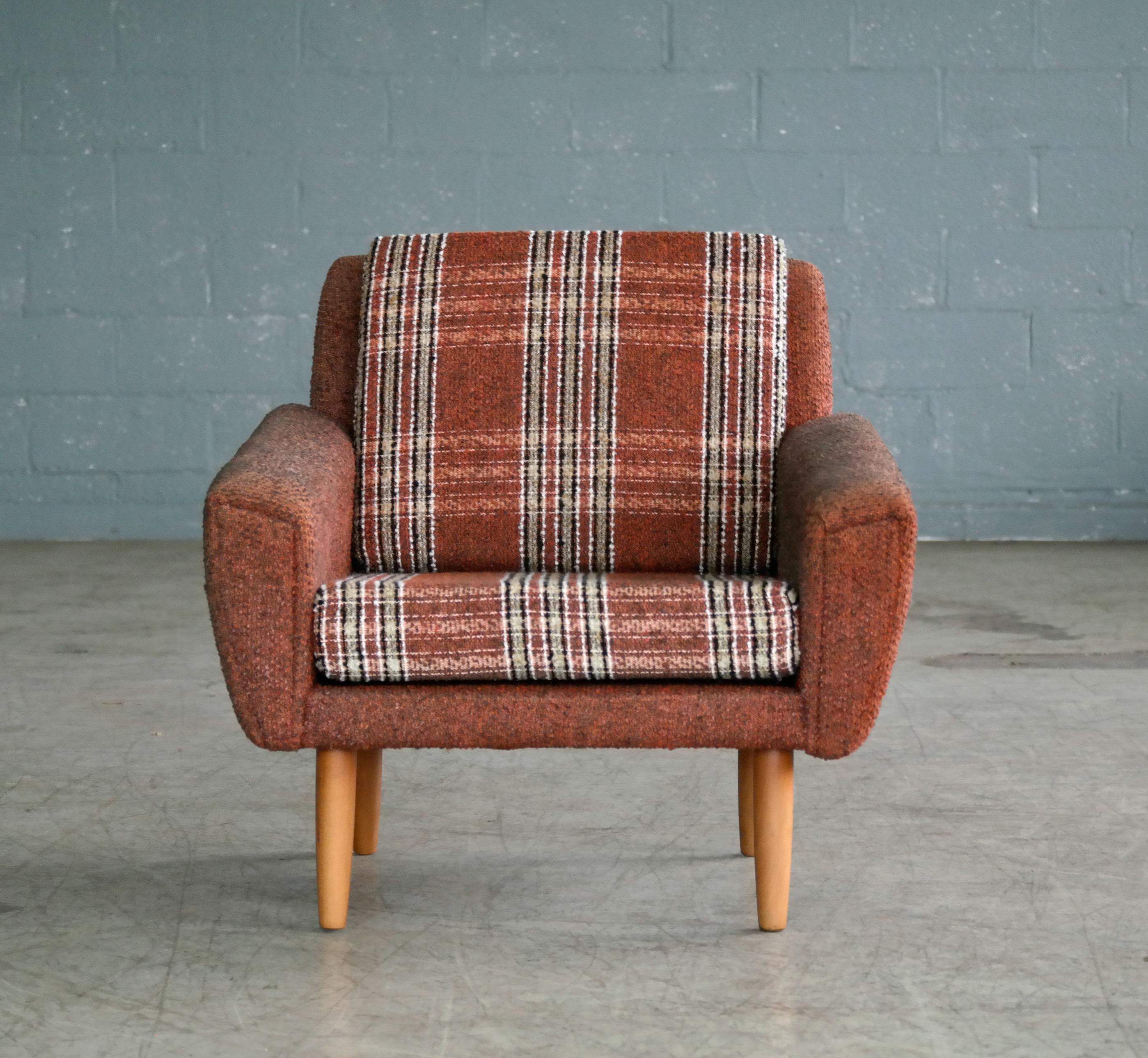 Classic 1960s easy chair possibly designed by Kurt Østervig for Ryesberg Mobler. The chair bears strong resemblance to Ostervig's characteristic design with tear drop front panels continuing to the backside of the chair but we are unsure of the