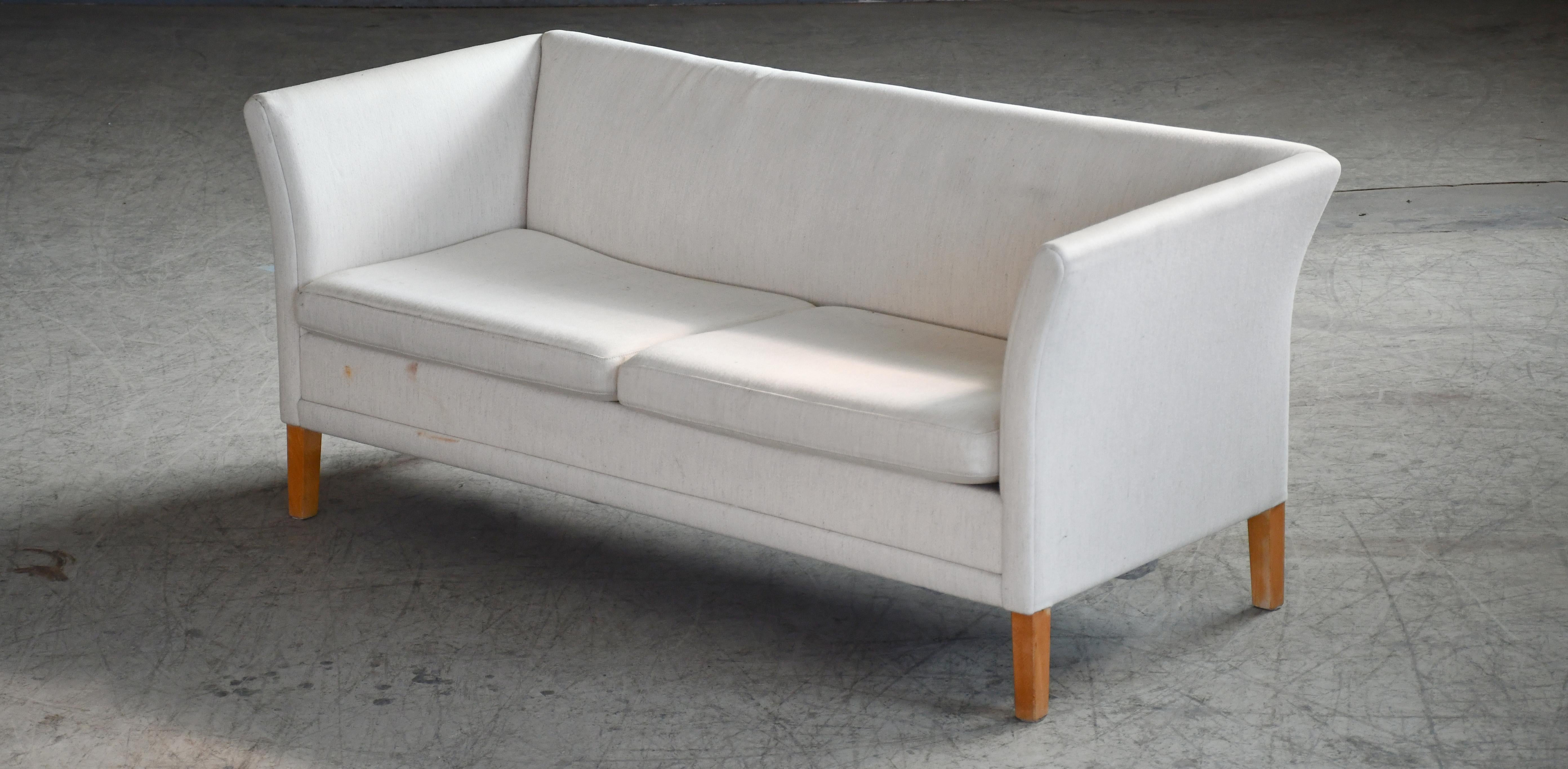 Beautiful Classic Danish design very similar to Grete Jalk's one of the grand ladies of Danish design, and Johannes Hansen's model JH 180. Simple yet very elegant and refined design beautiful from all angles. Raised on solid teak legs. The original