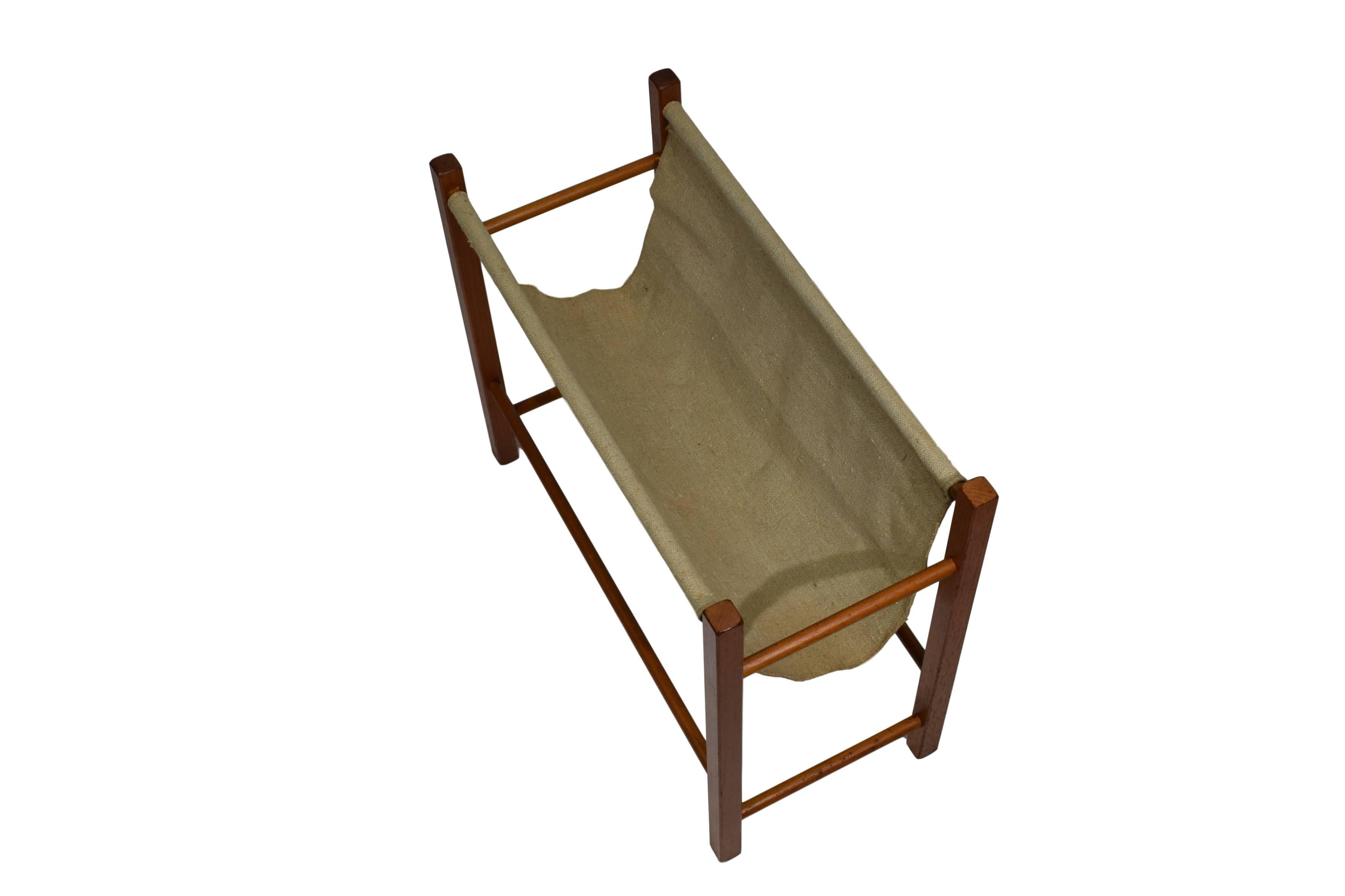 A Danish midcentury magazine rack with canvas sling. The frame is made from teak. 



 