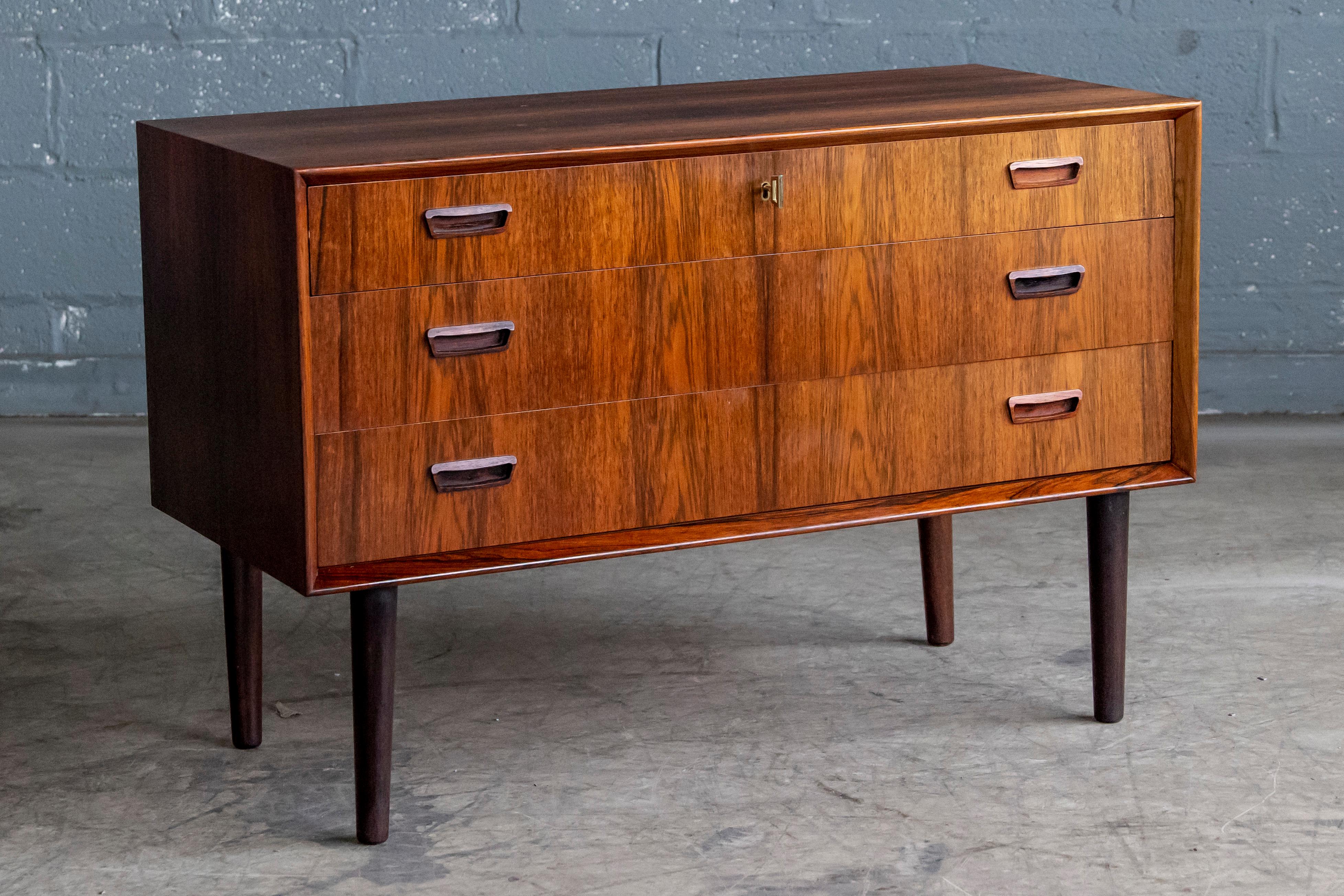 Beautiful classic Danish midcentury dresser or chest of drawers made from rosewood probably circa 1960 by Bornholm Mobler and Designer Johannes Sorth (market on the back) Jewelry organizer in the top drawer. Very desirable size in rosewood veneers