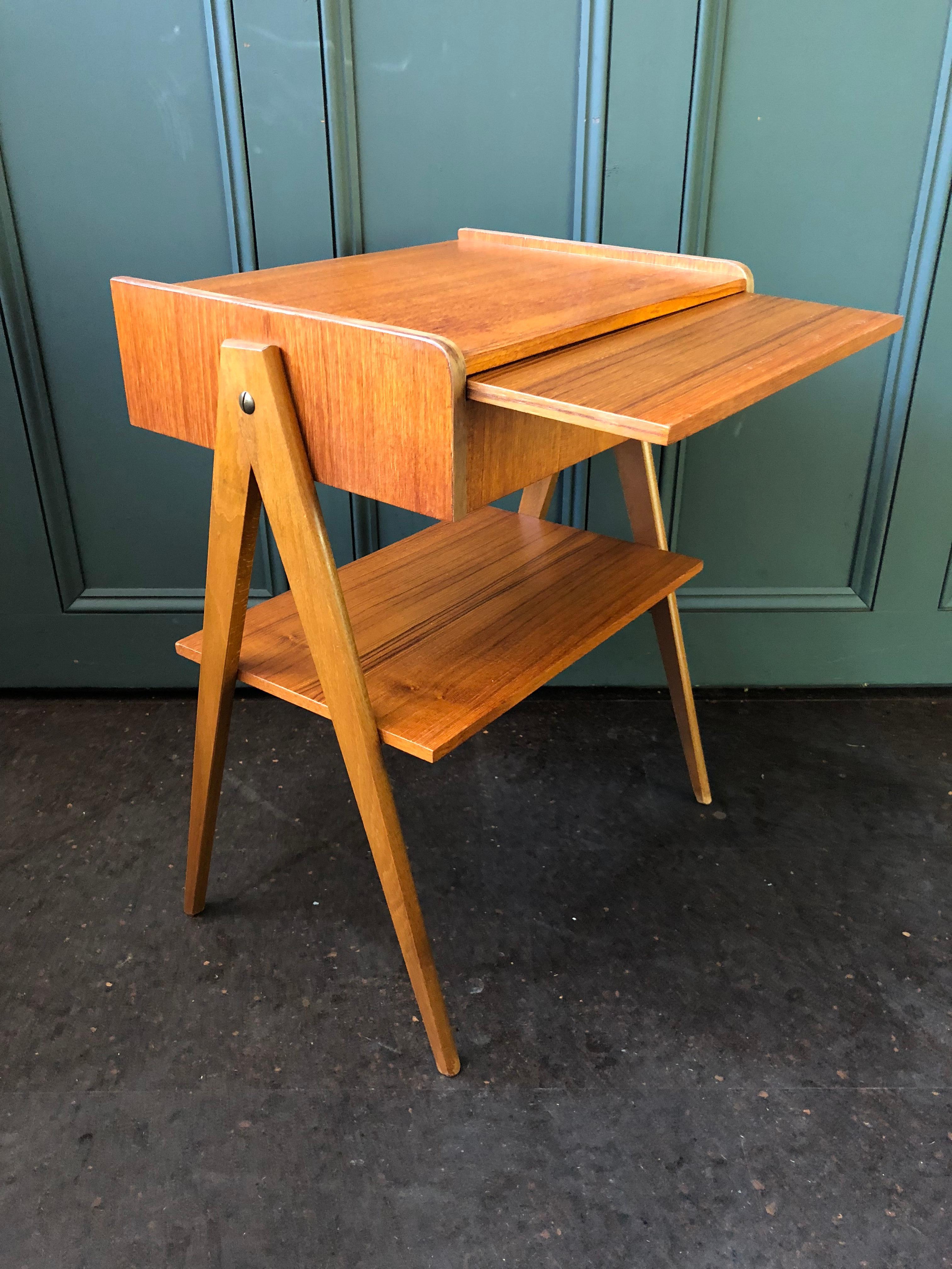 Very unusual pair of Danish midcentury bedside nightstands with slide out shelf. These nightstands were produced in Denmark, circa 1960. Teak and oak construction.