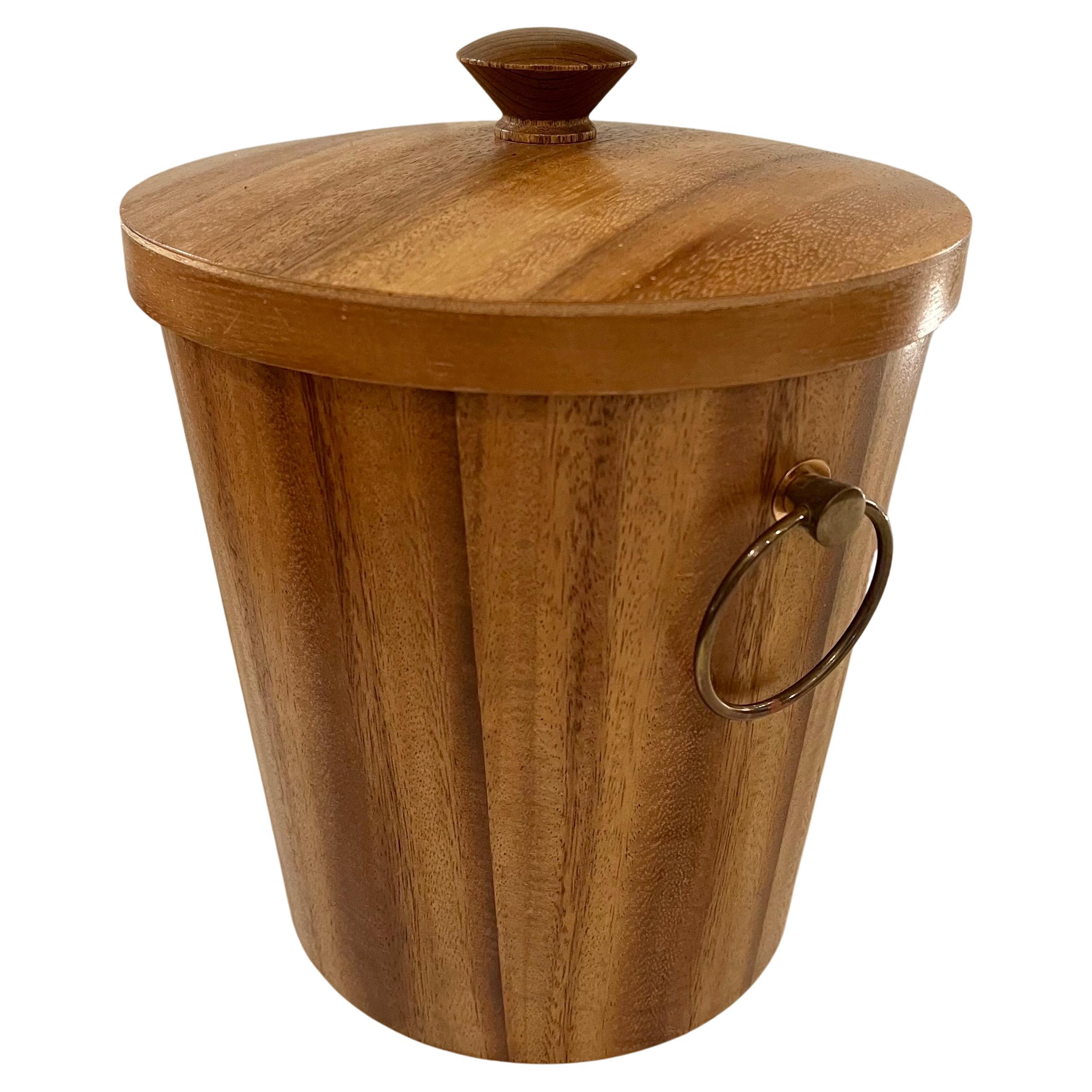 Unique and beautifully crafted Danish midcentury walnut with brass handles ice bucket. This piece has minimal, clean lines while enveloped in the grain of light walnut with an insert of aluminum. Linear in shape but rich in style.