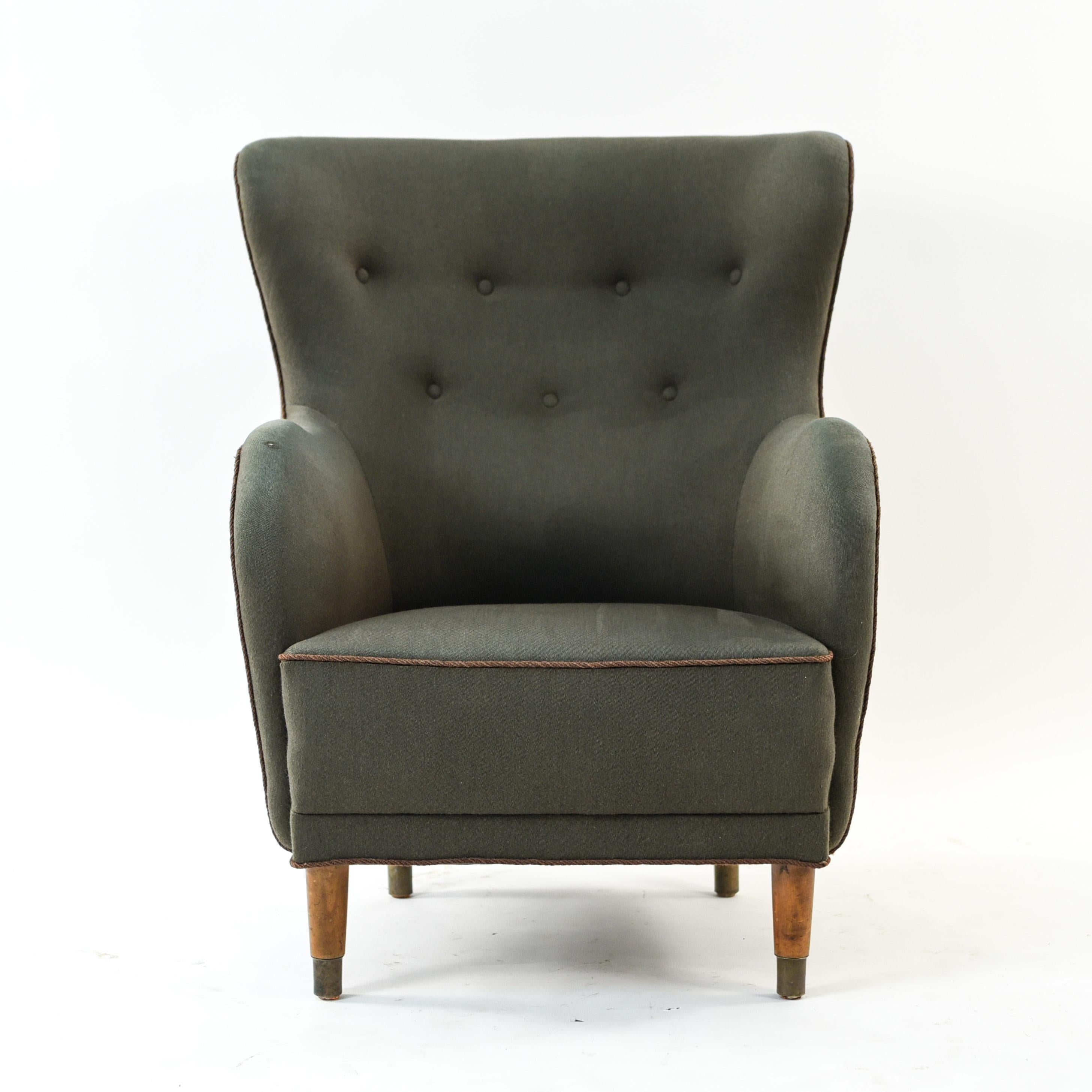 This Danish midcentury wingback chair is in the style of Mogens Lassen. A very comfortable chair in a highly desirable form.
