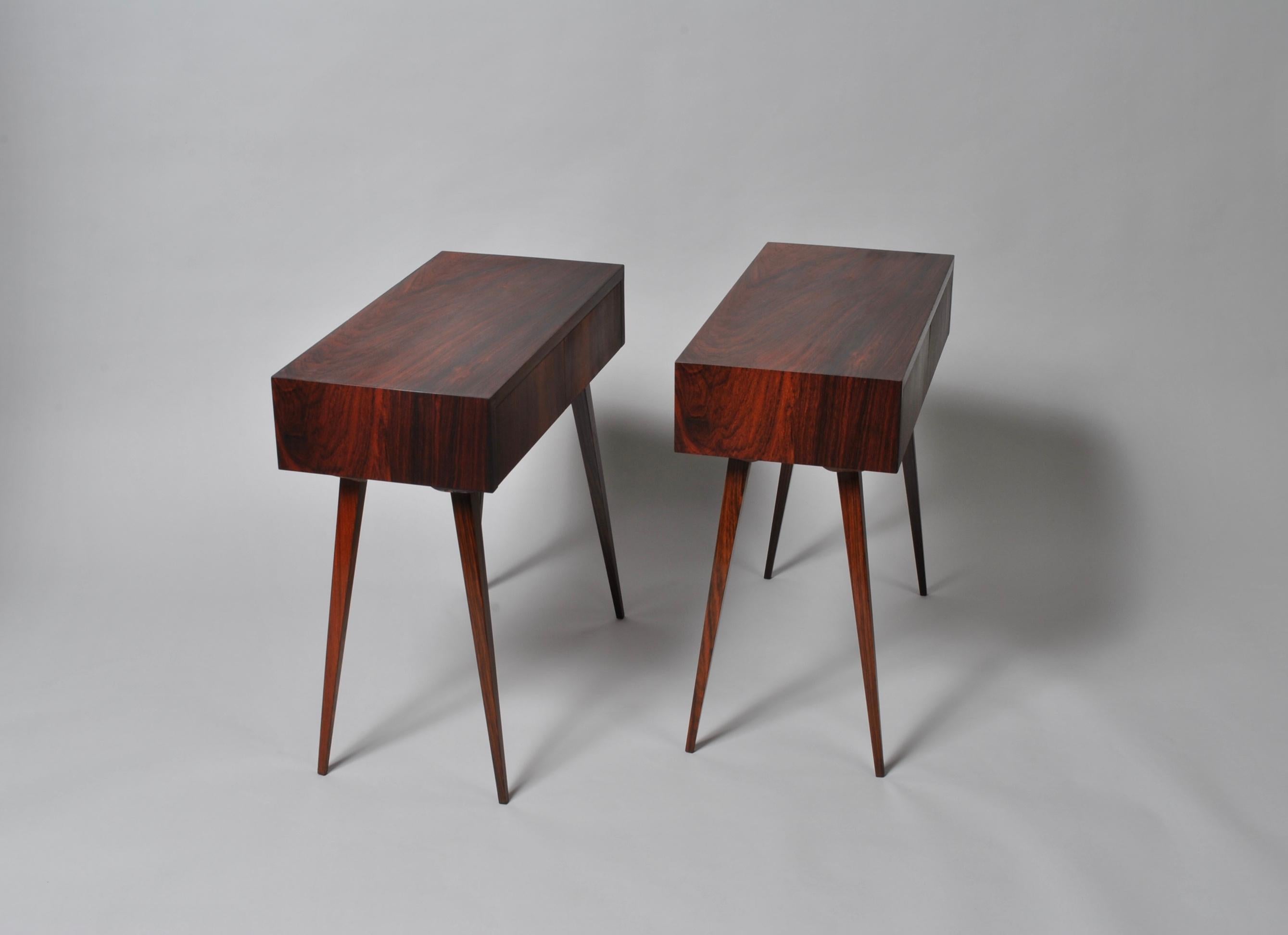 A striking pair of Danish midcentury modernist nightstands or end tables. Handmade one of a kind pieces, circa 1960, Denmark. Tall slender tapering angular legs. Each table has 2 small drawers. Very clever use of the veneer to wrap the boxes and