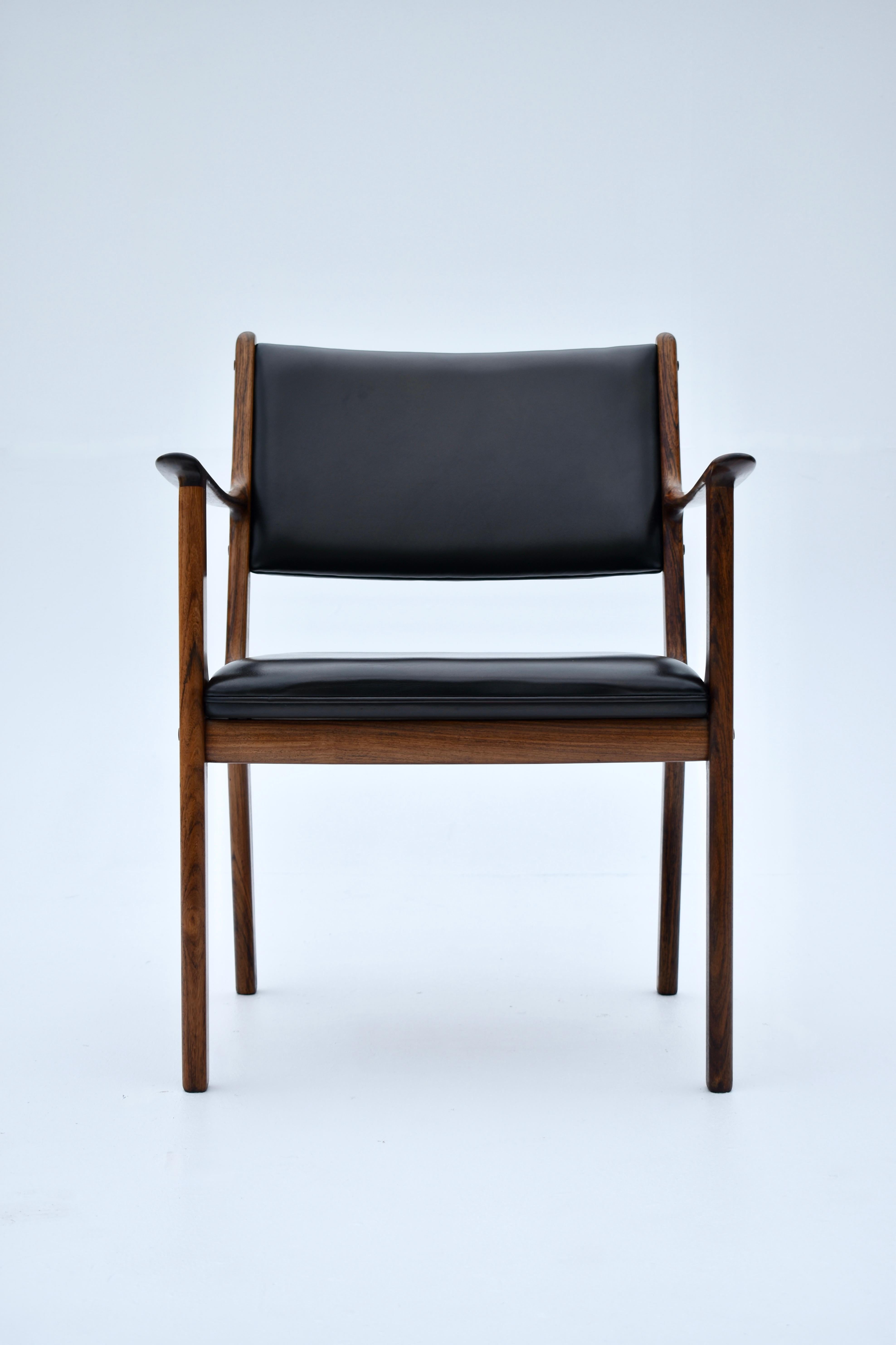 Very handsome Model PJ412 armchair designed by Ole Wanscher for Poul Jeppesen.

Constructed from highly figured solid rosewood with original leather upholstery.

Typical stripped back minimilism with clear references to classical design so