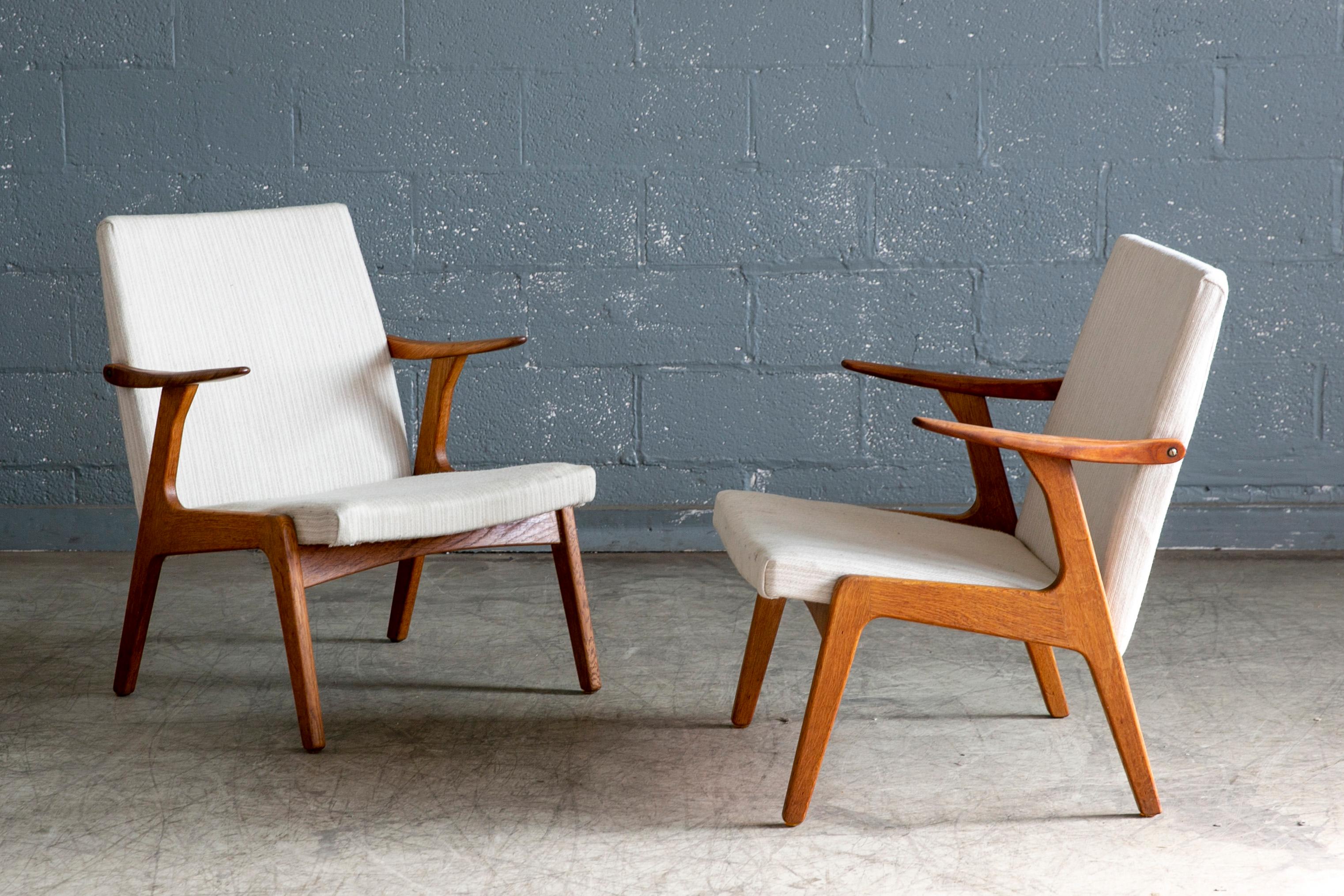 Great set of 1950s low back easy chairs by attributed Kurt Olsen and Glostrup Mobelfabrik. Olsen's characteristic design of small dynamic lounge chairs raised on frames of solid oak and with armrests in solid teak with good grain and color. Original