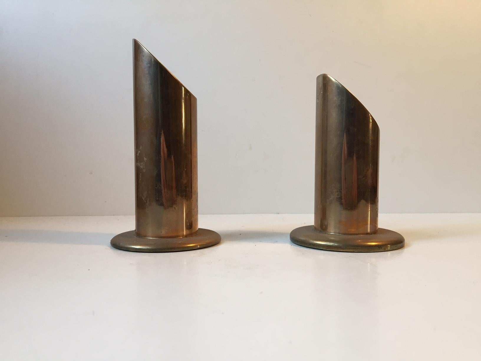 A pair of heavy brass candle holders. Manufactured by Danalux in Denmark in the 1960s. The candleholders can be fitted with either tea lights or large/bloc candles.