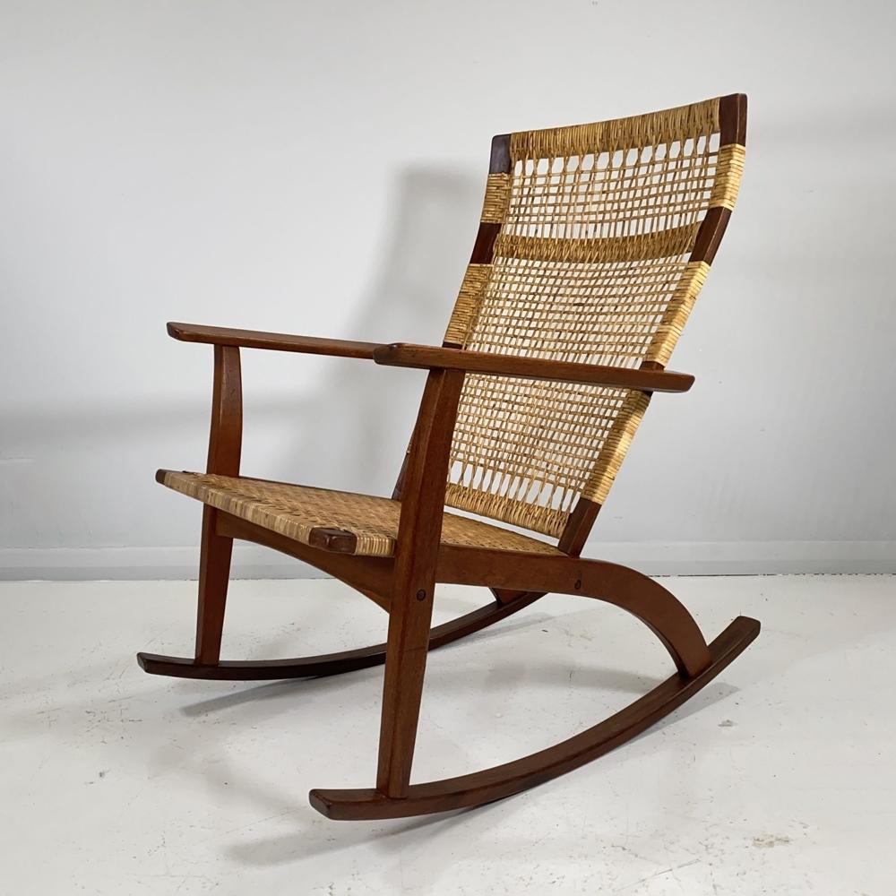 A Danish midcentury rocking chair designed by Hans Olsen and produced by Juul Kristensen. This is a very rare model rocking chair and only a few survive in this condition, if at all. The seat and backrest are woven with cane over the teak and