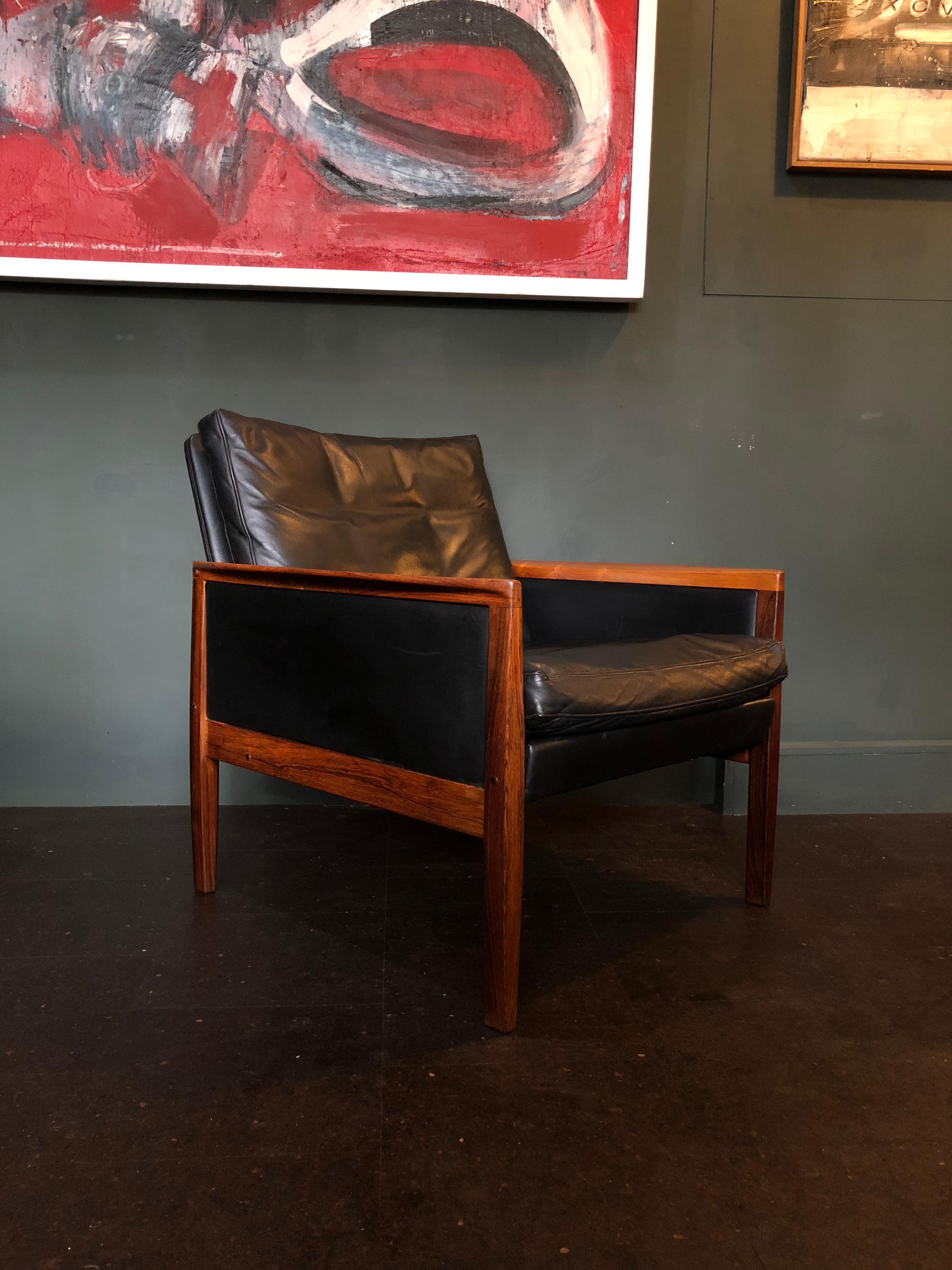 Incredible Danish Midcentury rosewood and leather lounge chair designed by Hans Olsen for Juul Christensen. Constructed from Rosewood and with original black Leather circa 1960. In wonderful condition throughout. Thoroughly cleaned and conditioned