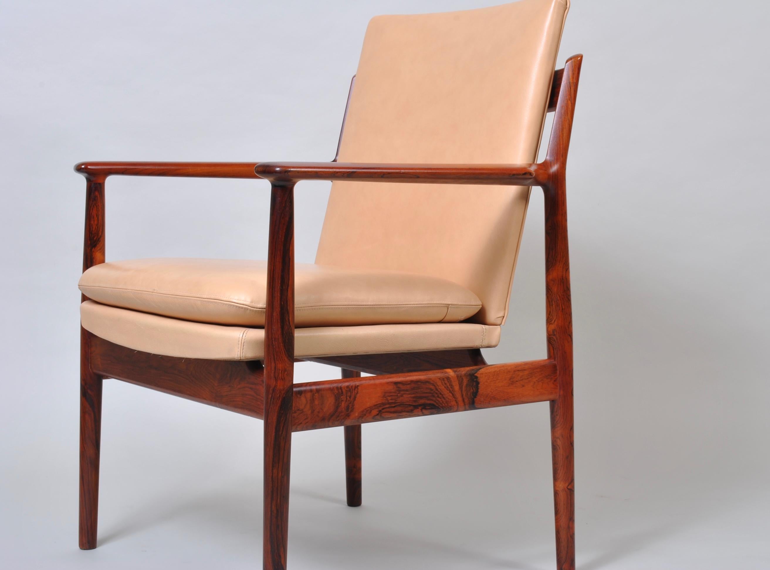 A wonderful Danish midcentury rosewood and leather armchair by Arne Vodder. Extremely nice rosewood frame with some very interesting grain and coloring. A classic design by Arne Vodder for the Sibast Furniture company. Very comfortable chairs.