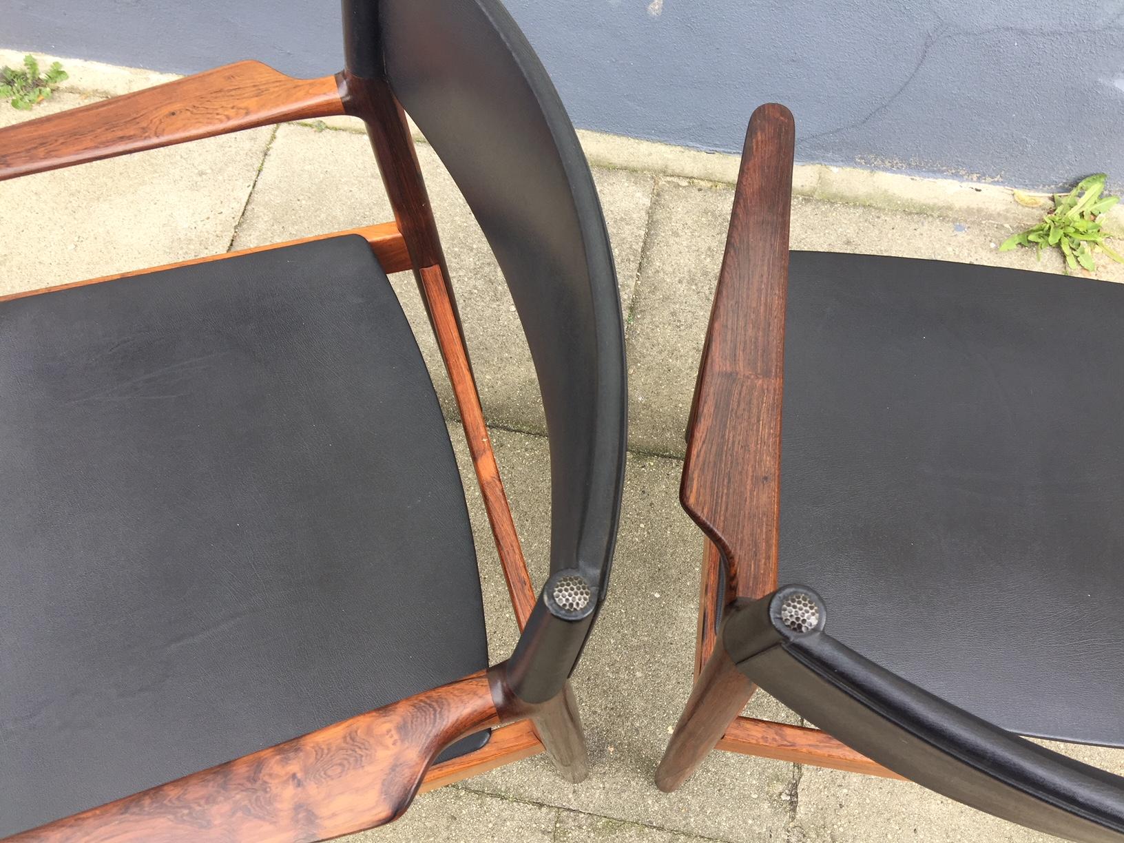Pair of rare Danish Modern armchairs designed by Erik Wørts in 1960 and manufactured by Vamo in Denmark. This model is called 'Erika' and was Wørts favorite design. The pair feature solid Brazilian rosewood frames with black nappa upholstery