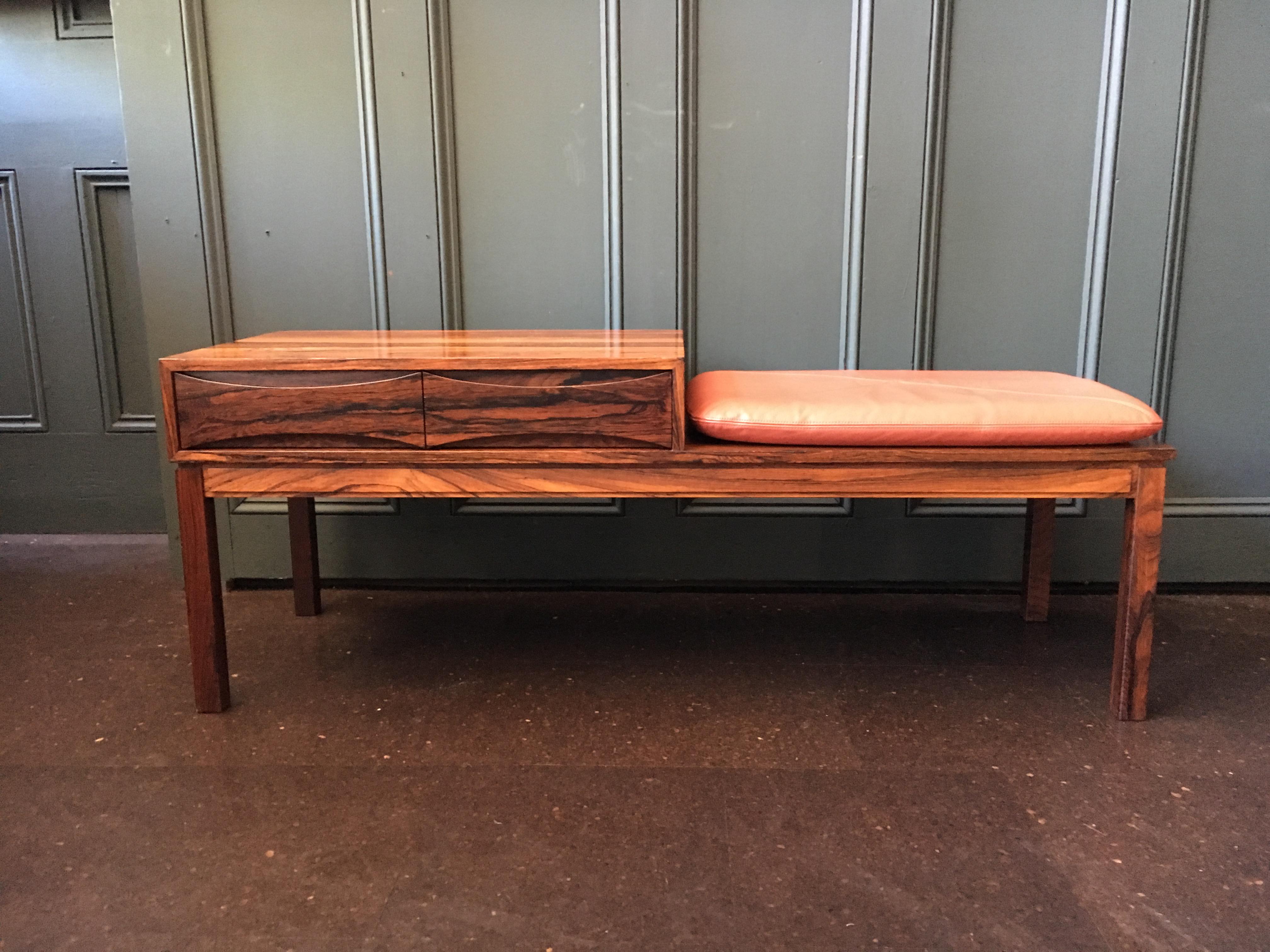 This amazing lowboy piece of midcentury design can be used in a variety of interior applications. A rosewood hall entry unit or bench with drawers. Original leather seat pad. Most likely an Arne Vodder design with his signature bow-tie drawers