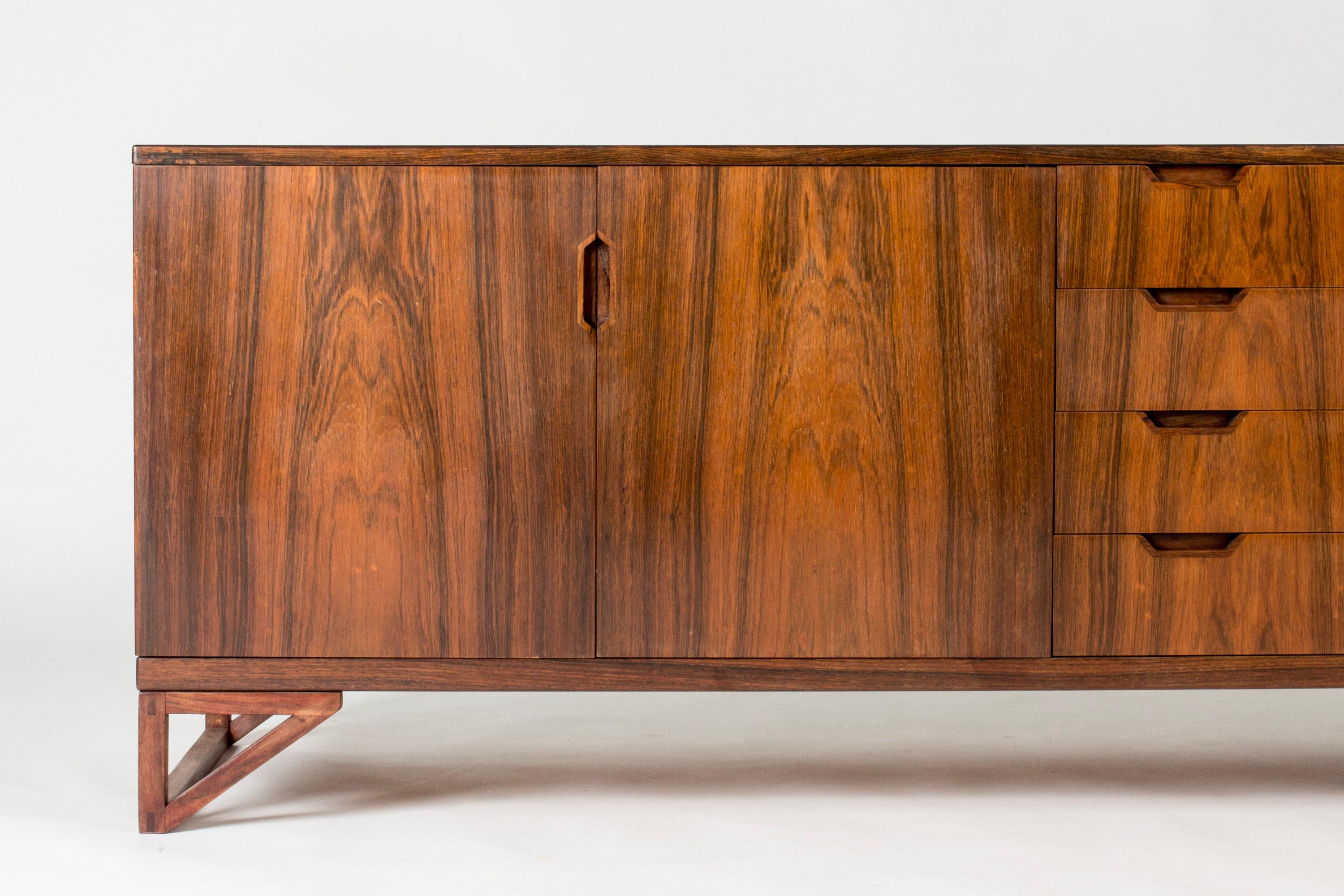 Beautiful rosewood sideboard by Svend Langkilde. Elegantly sculpted handles, and decorative triangle formed legs. Neater size.