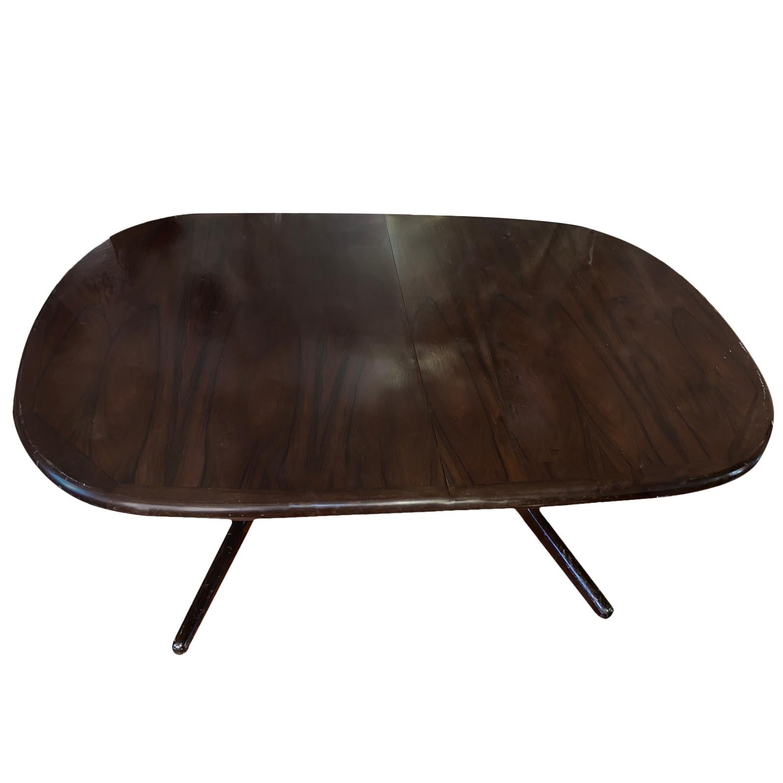 A circa 1960's Danish rosewood oval dining table with 2 extension leaves that measure 19