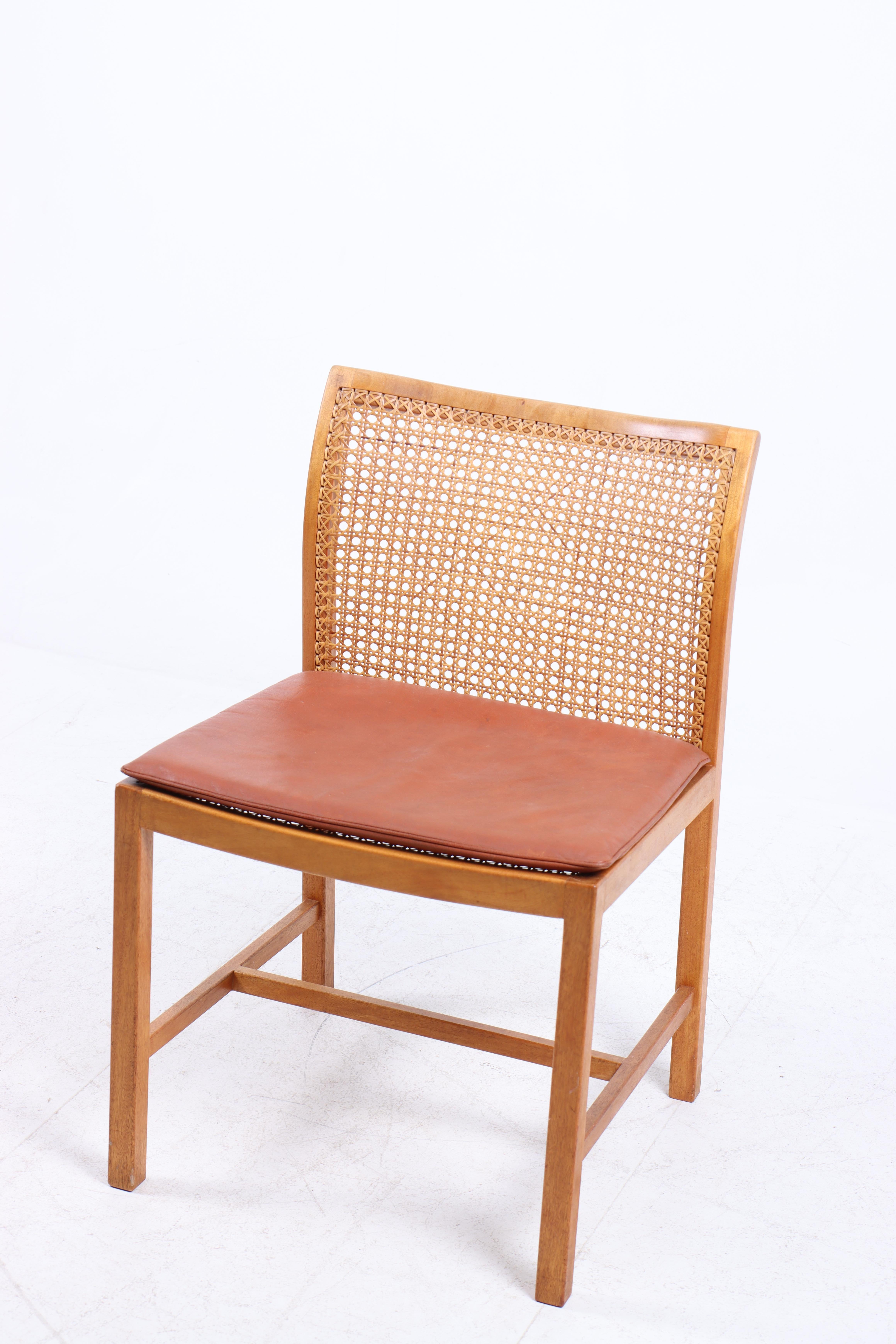 Side chair in mahogany, cane and patinated leather. Designed by Ditte & Adrian Heath for Søren Horn cabinetmakers. Made in Denmark in the 1960s. Great original condition.