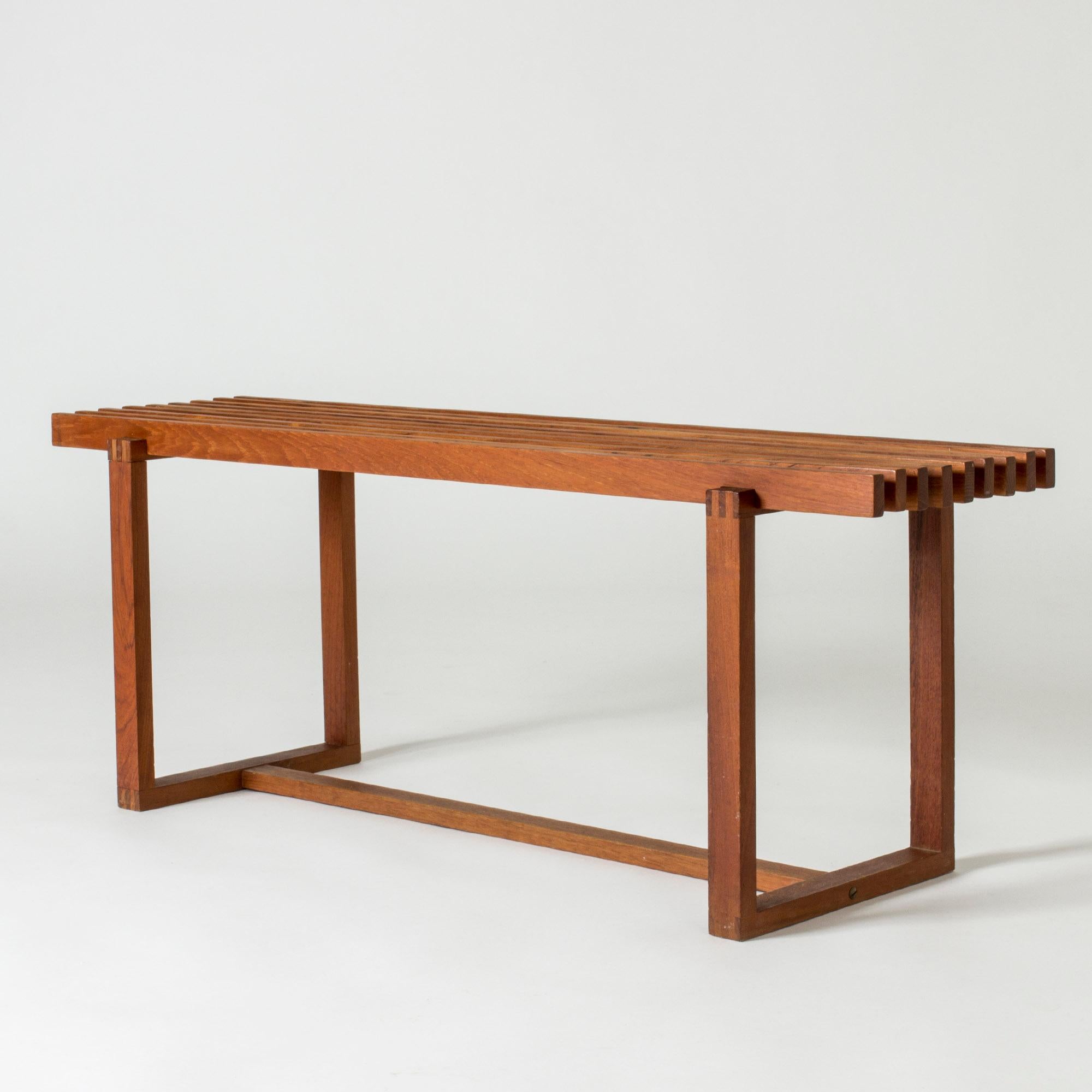 Neat Danish mid-century bench, made from teak. Cool graphic lines, perfect as a long side table or flower bench.