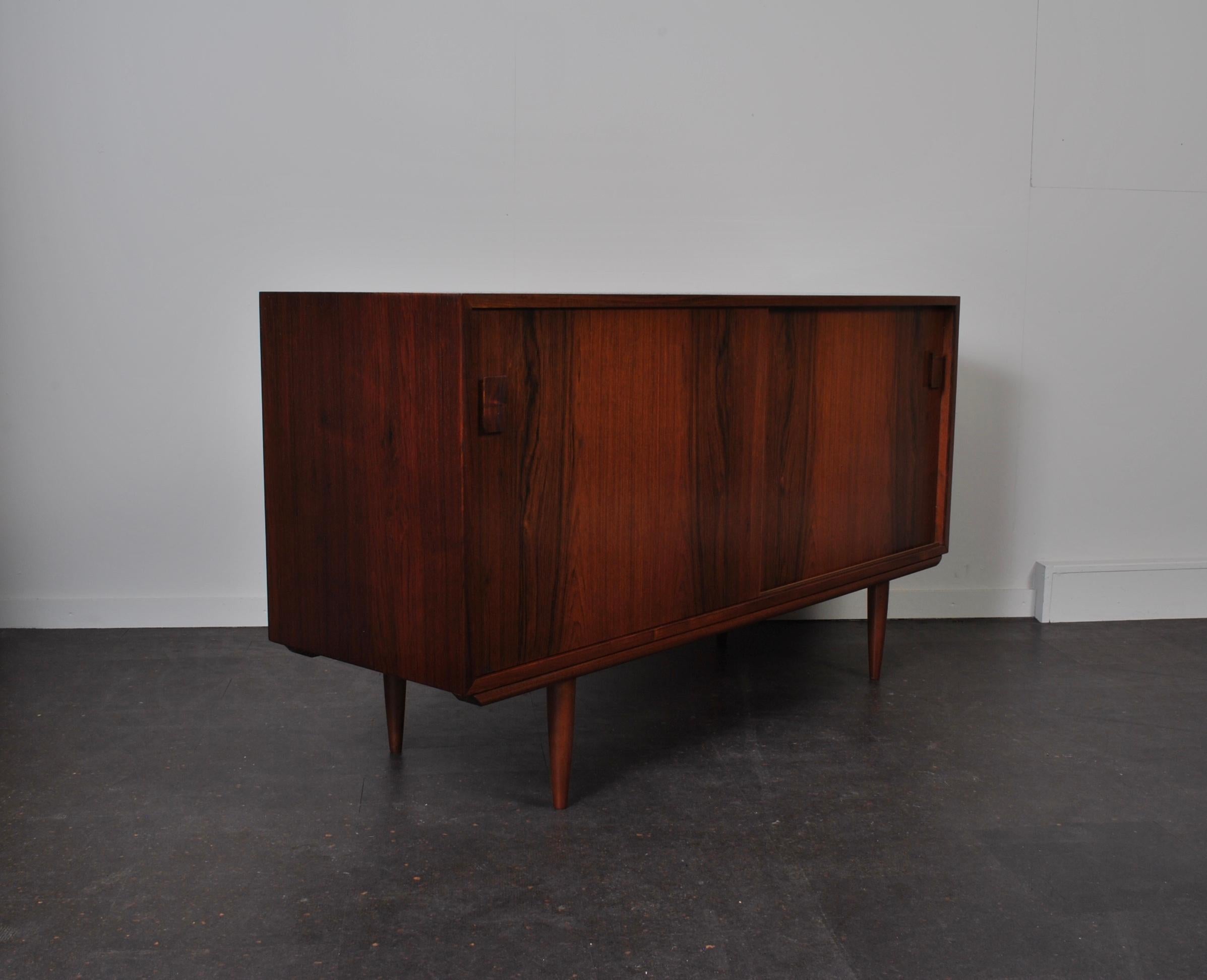 Mid-size Danish midcentury sideboard or credenza. Wonderfully simple and sleek modernist design. 2 available.
Interior removable or height adjustable shelves to both sides.
  
