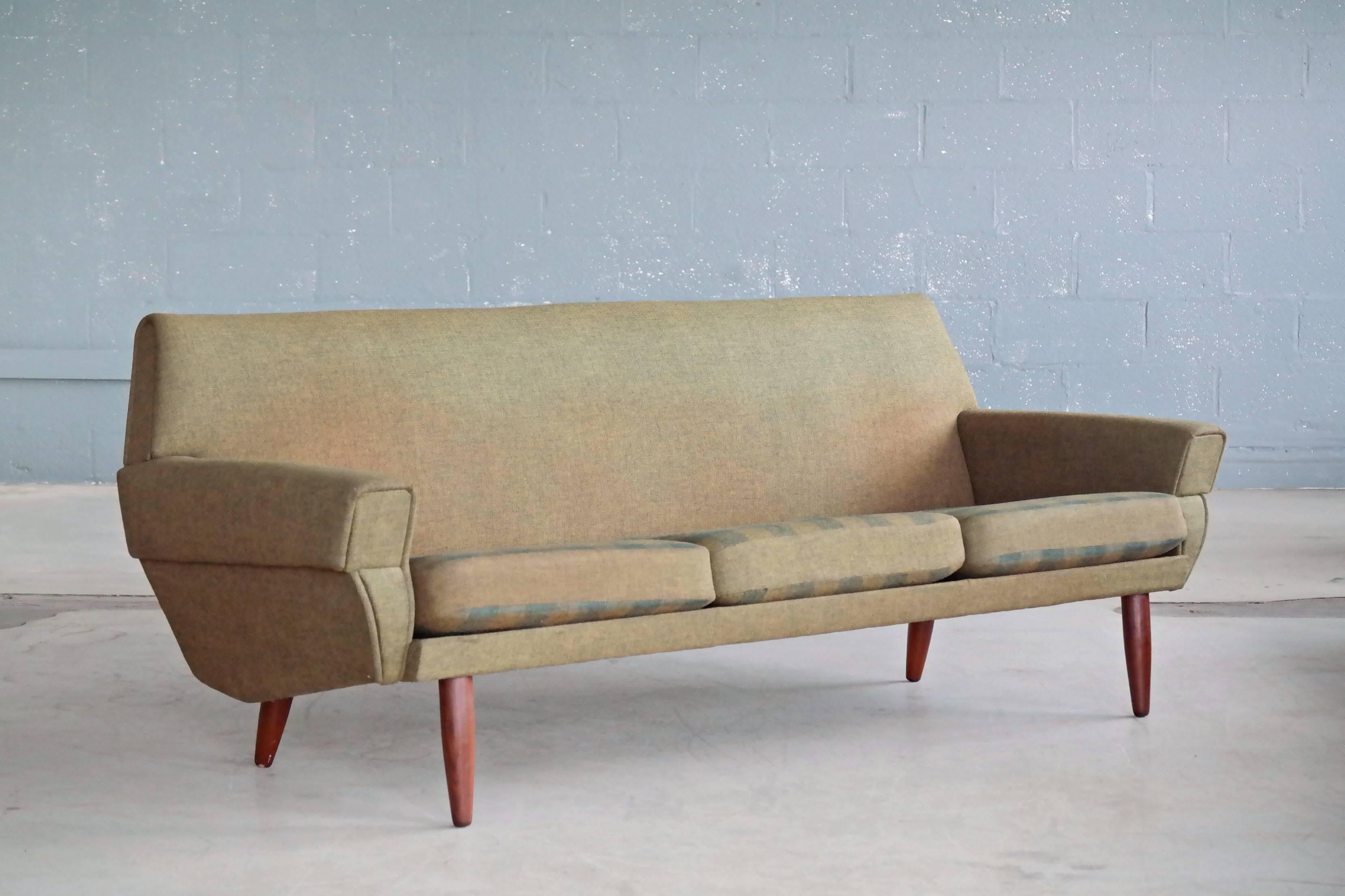 Classic Danish 1960s designed living room set. Based on the style and build quality it appears to be made by either Ryesberg or Rolschau Mobler of Denmark both of which produced furniture for Designer Kurt Ostervig. This sofa is very reminiscent of