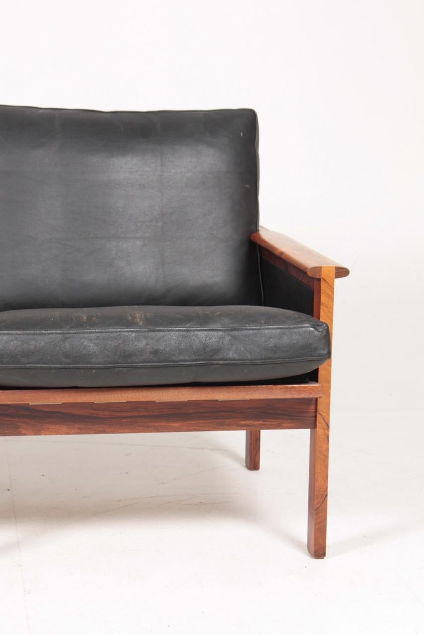 Capella sofa in rosewood and leather designed by Illum Wikkelsø and made by Eilersen in Denmark - great original condition.