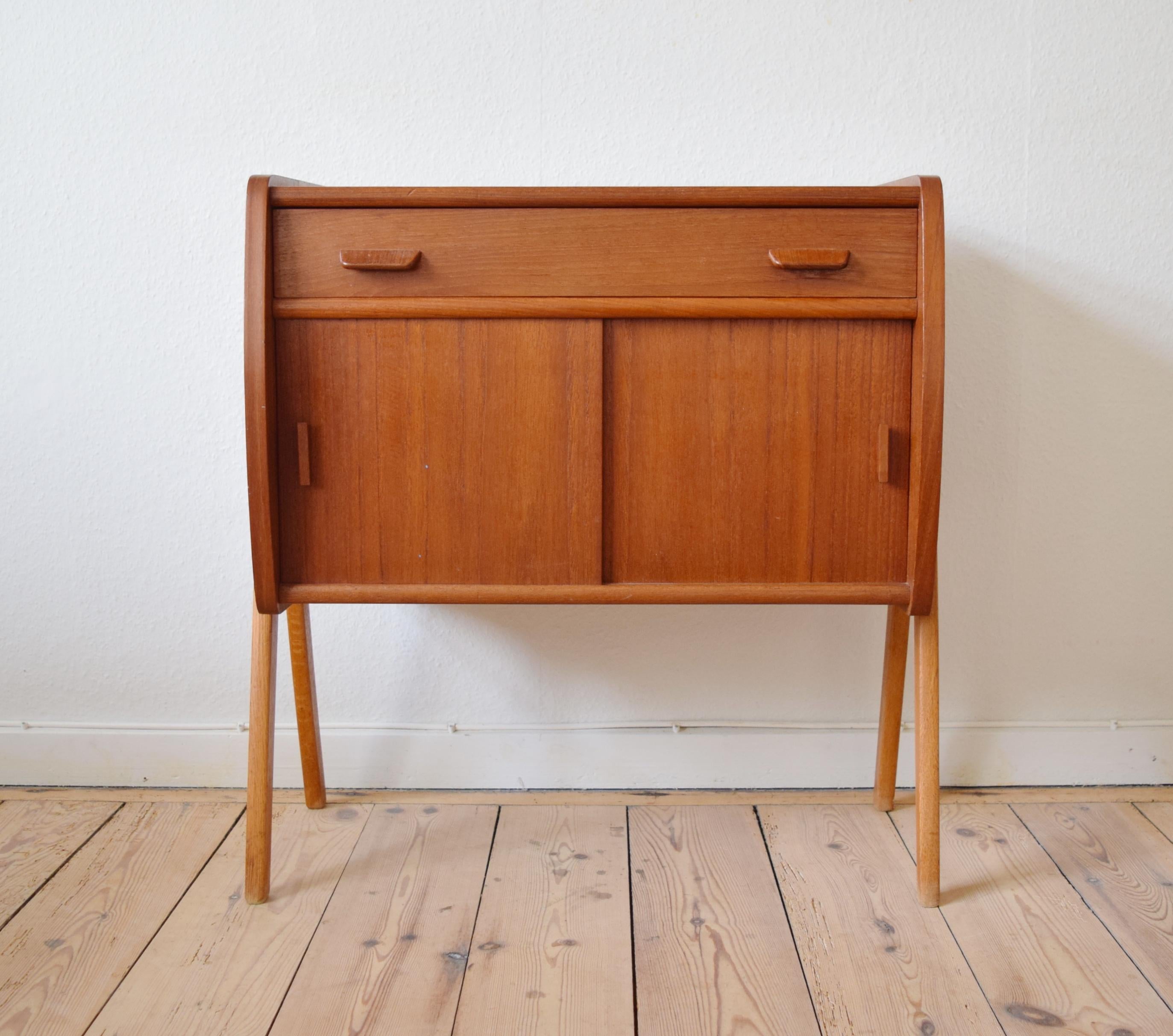 Poul Volther small cabinet with drawer and two sliding doors with maple interior. Sits on 'compass' shaped solid teak legs. Manufactured in Denmark in the 1960s.
Poul M. Volther was a trained cabinetmaker who also attended the School of Arts &