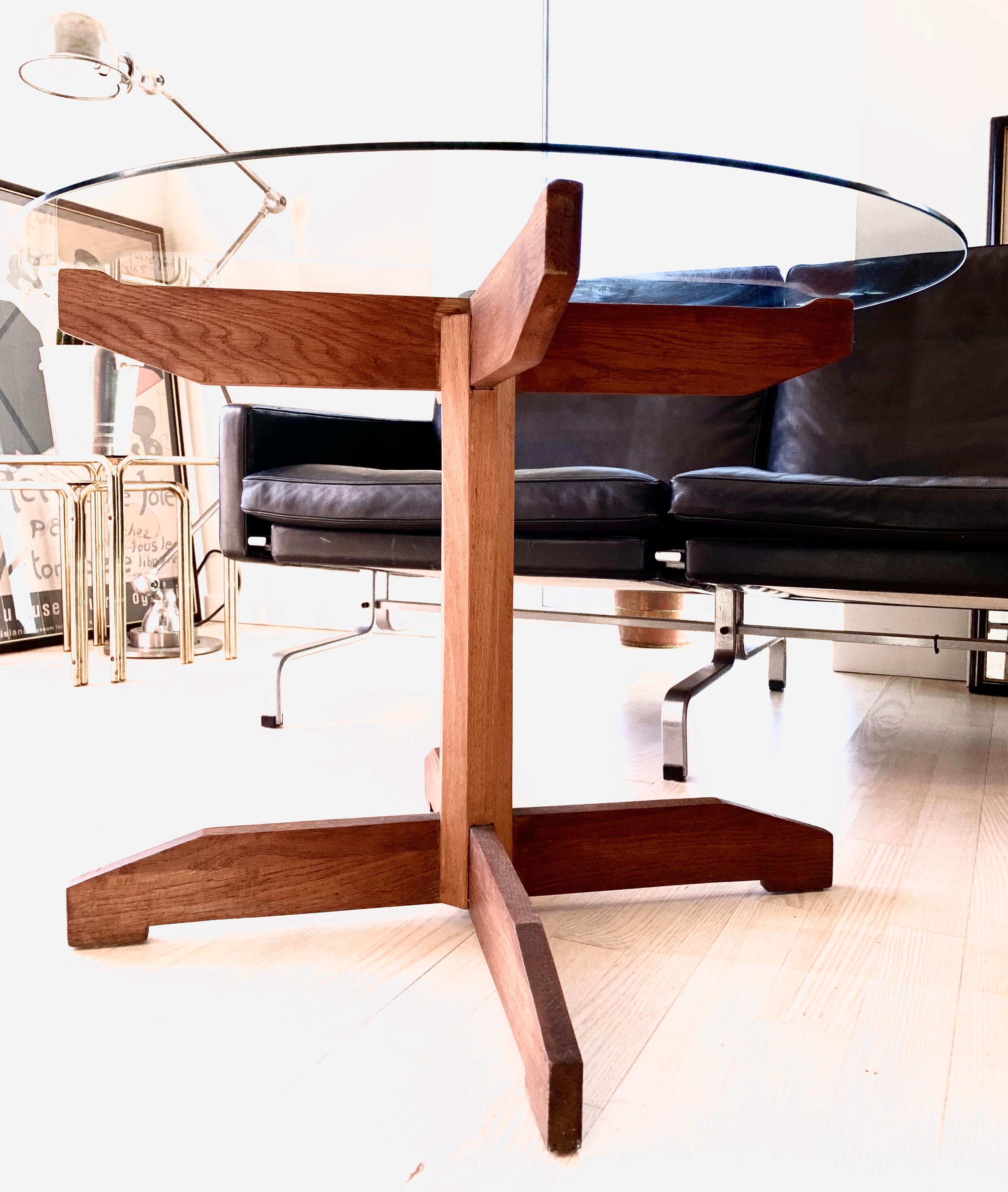 Rare Danish teak coffee table featuring a star base mad of teak and a glass top.
  