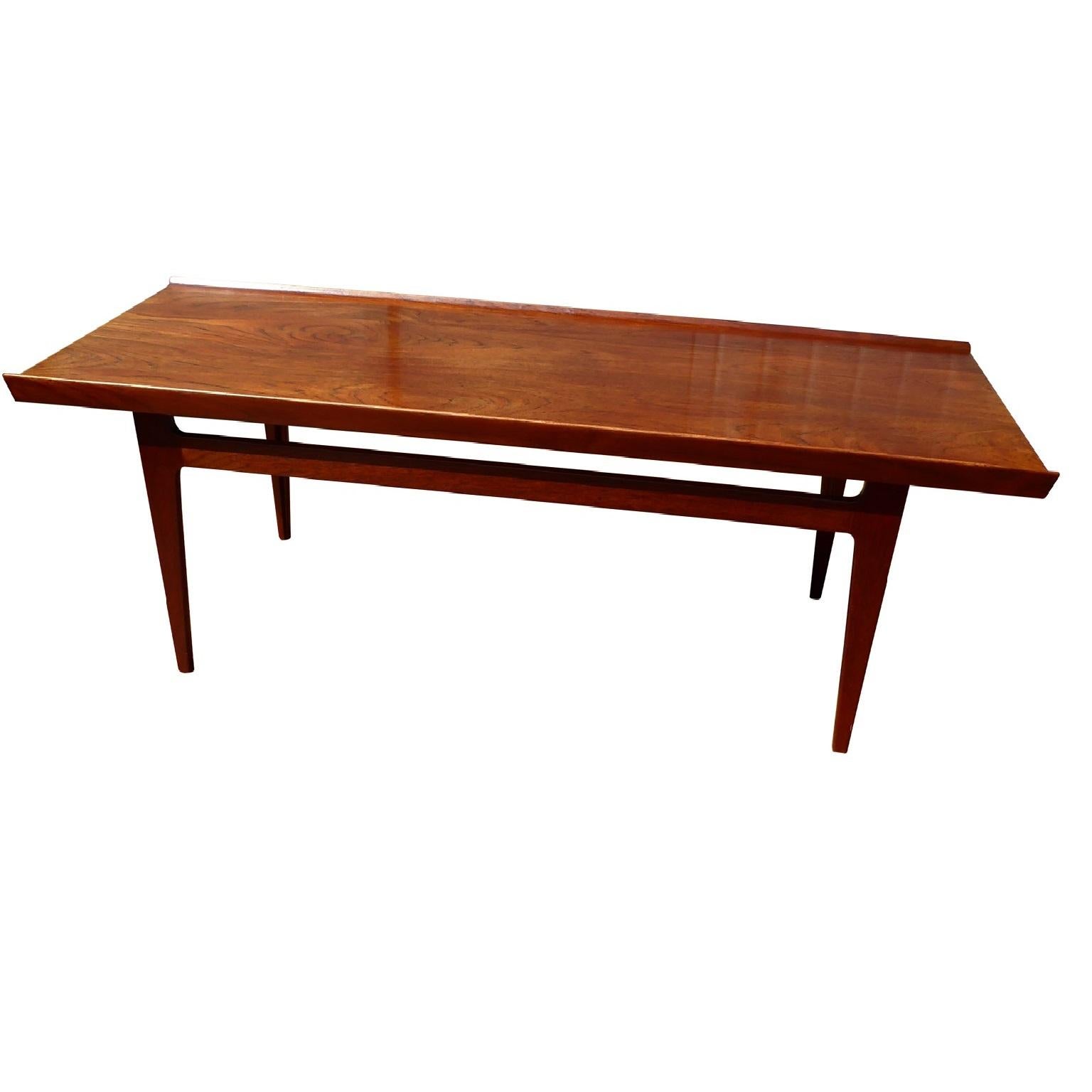 Danish lounge or coffee table designed by Finn Juhl and produced by France & Son,
Model # 532, circa 1959. In fantastic condition.

The rectangular lounge table is solid teak, with signature raised edges along the length of the table, as well as