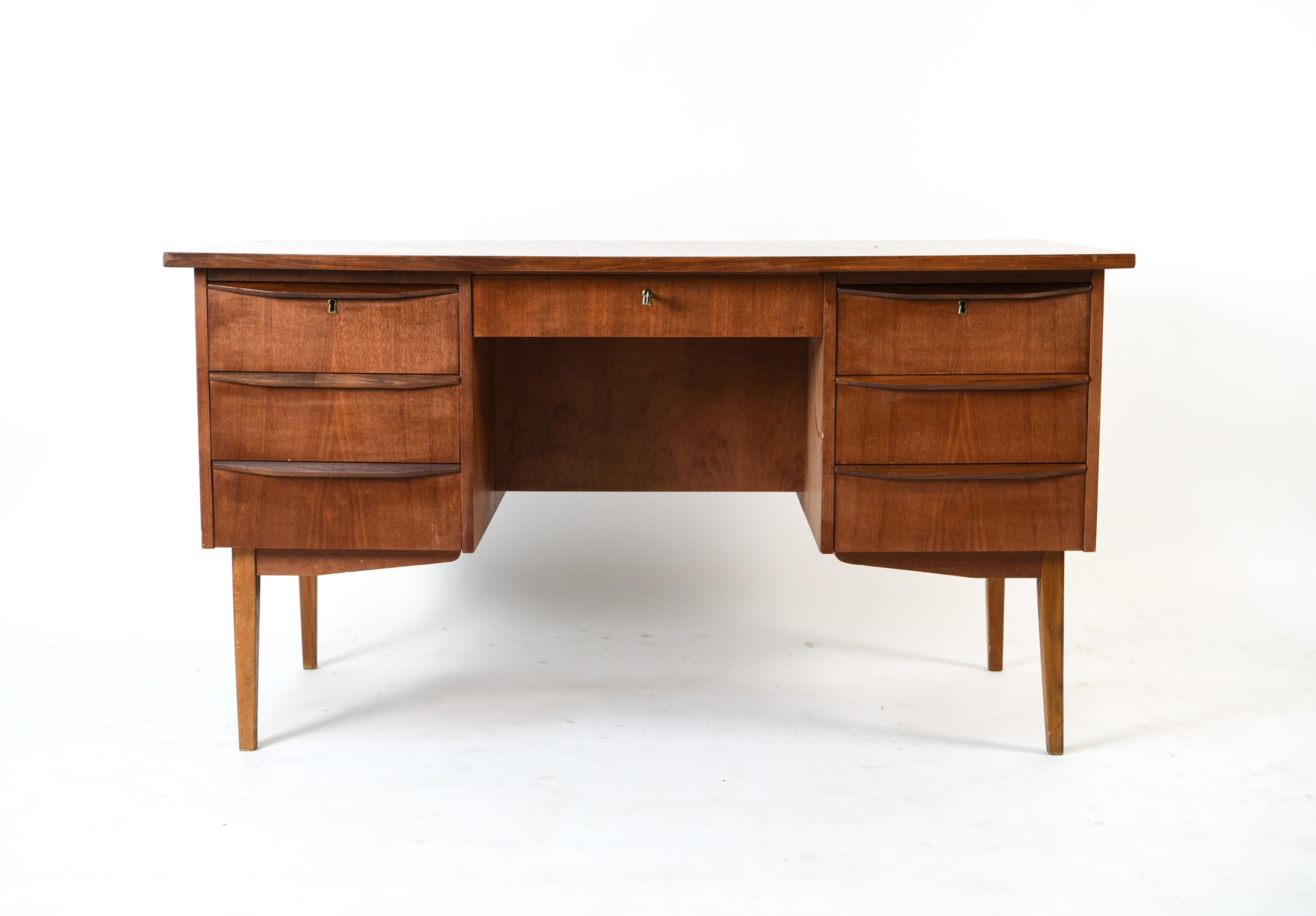 This Danish midcentury teak desk is a great way to incorporate modern Scandinavian design into an office space. This desk has ample storage in its many drawers and compartments, and sits upon slim legs which gives it a light appearance.