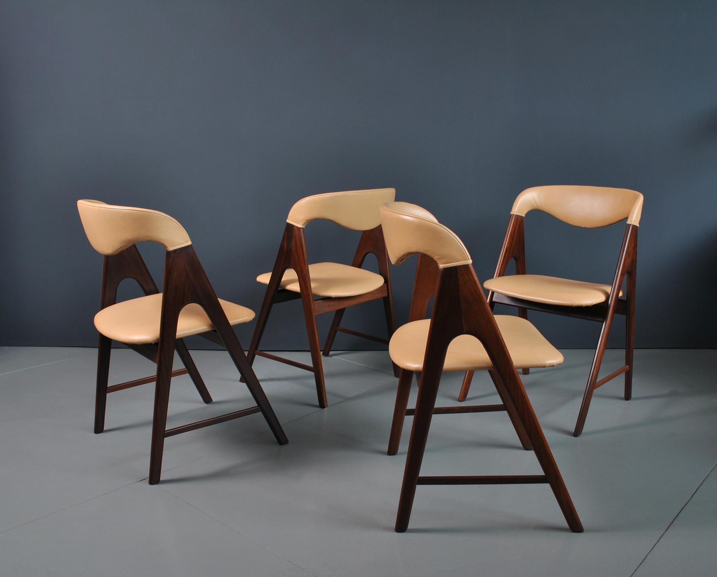 Set of 4 Danish midcentury teak dining chairs with new caramel crest leather. A very unusual walking leg design. Produced in Denmark circa 1950’s.