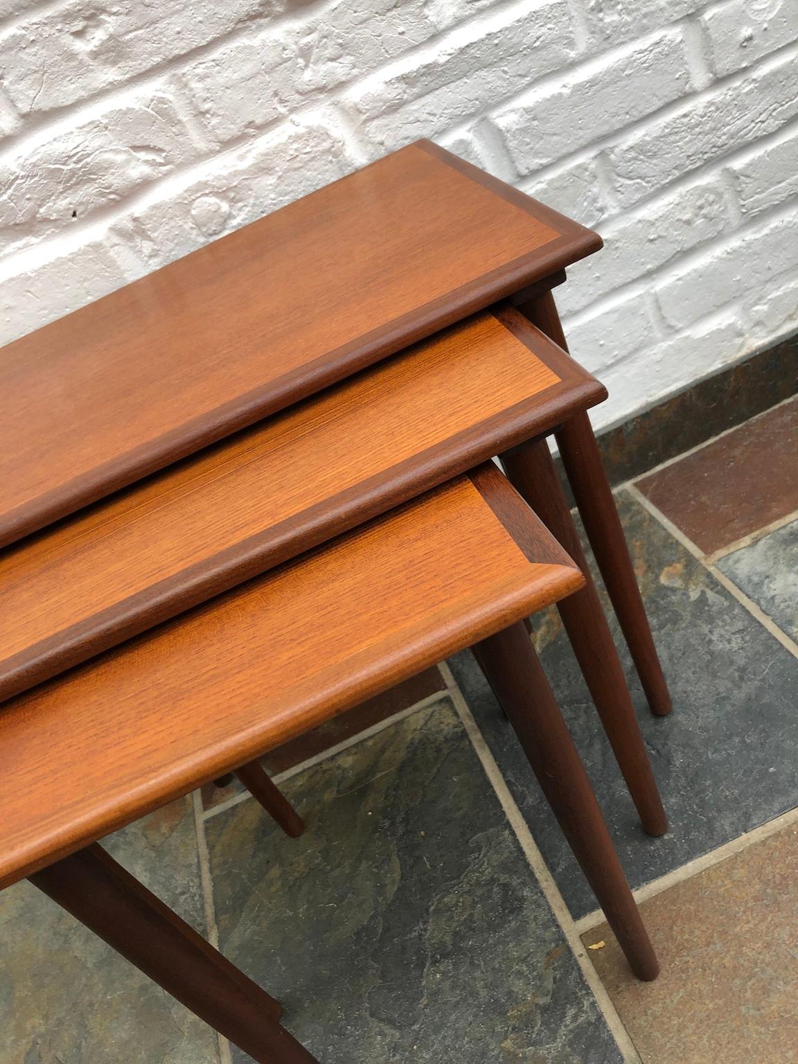 Danish midcentury teak nesting tables by Poul Hundevad, circa 1960s.
A nest of three teak nesting tables designed by Poul Hundevad and
manufactured by Fabian in Denmark.
Beautiful tapered legs the small and medium table slide into each