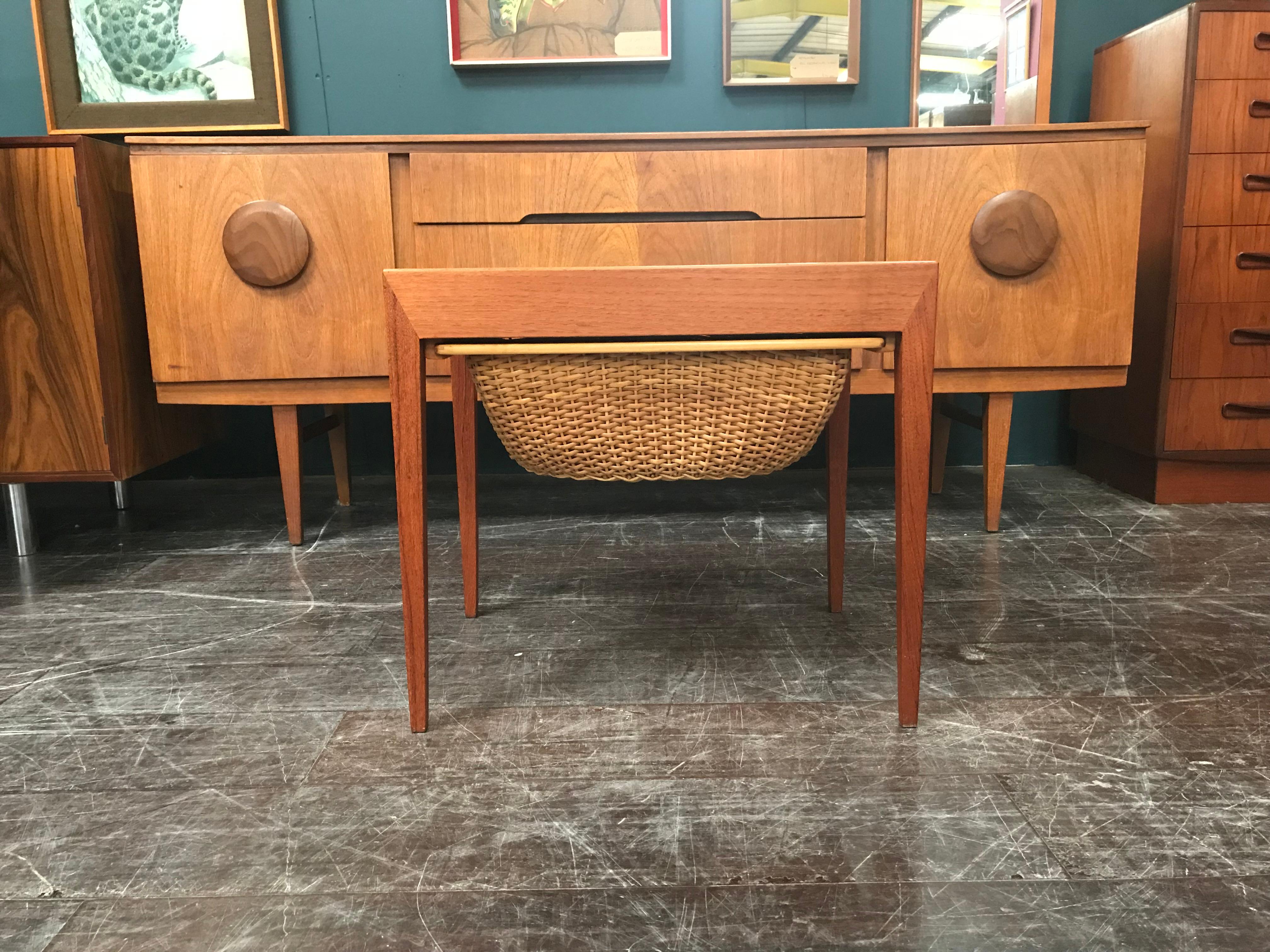 A rare chance to own a highly desirable piece of midcentury design. This little sewing table is beautifully made and can be used for a variety of purposes. Set on wheels, the trolley is easily wheeled to where it is needed but can be stored away
