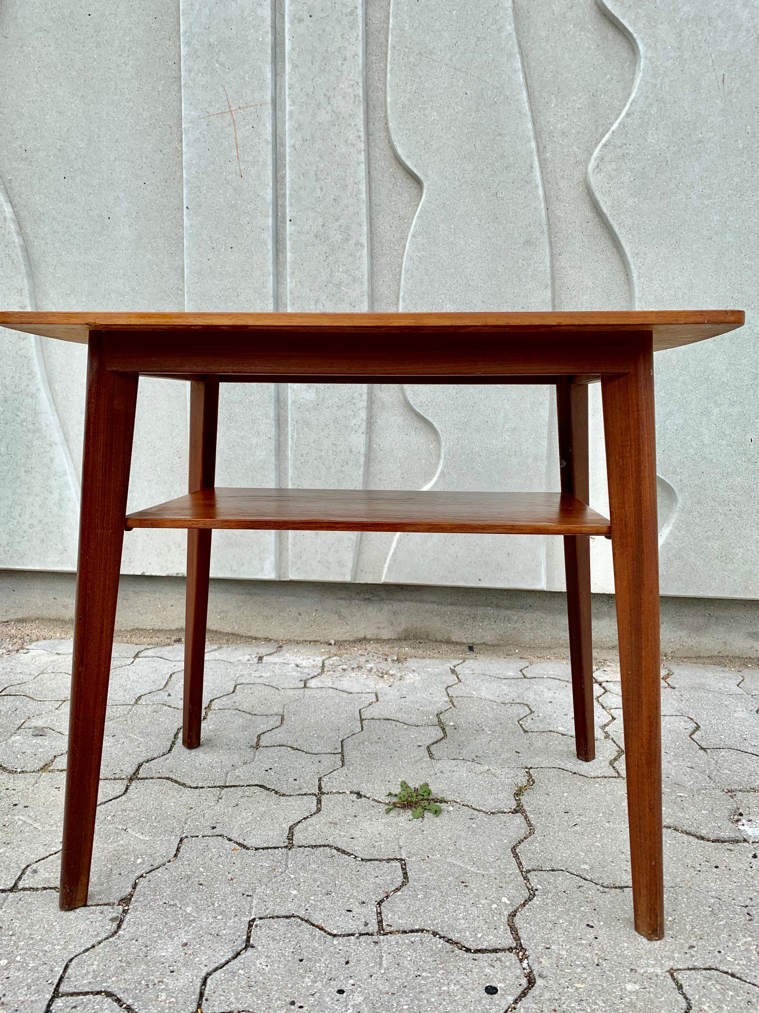 Small Danish side or coffee table with angular legs. Stunning wooden grains. Very good craftsmanship.