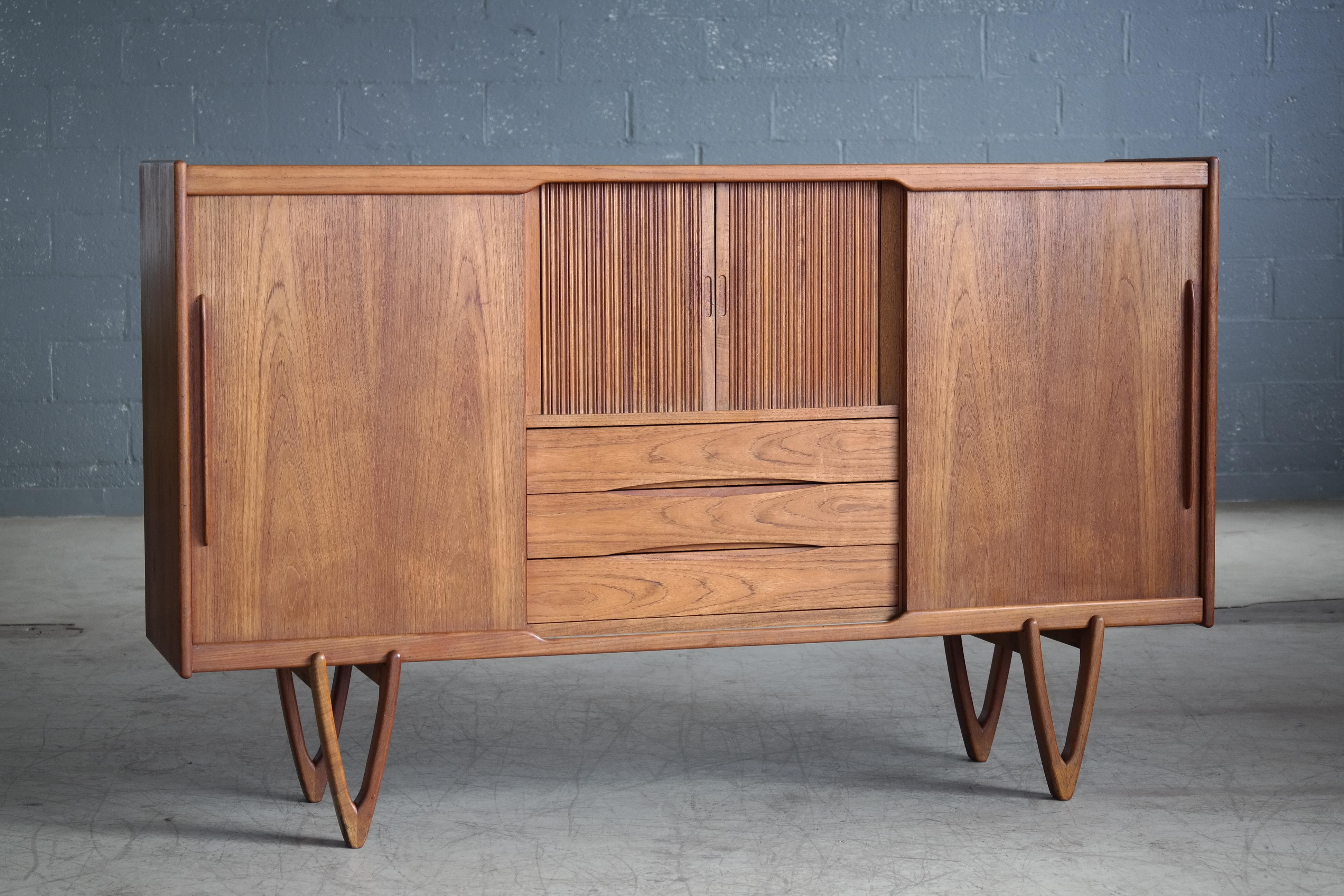 Fantastic Danish highboard manufactured in the late 1950s. Elegant timeless design piece with a nice size and presence about it without being imposing. The build quality is of the highest caliber with all veneers are solid ply with no use of
