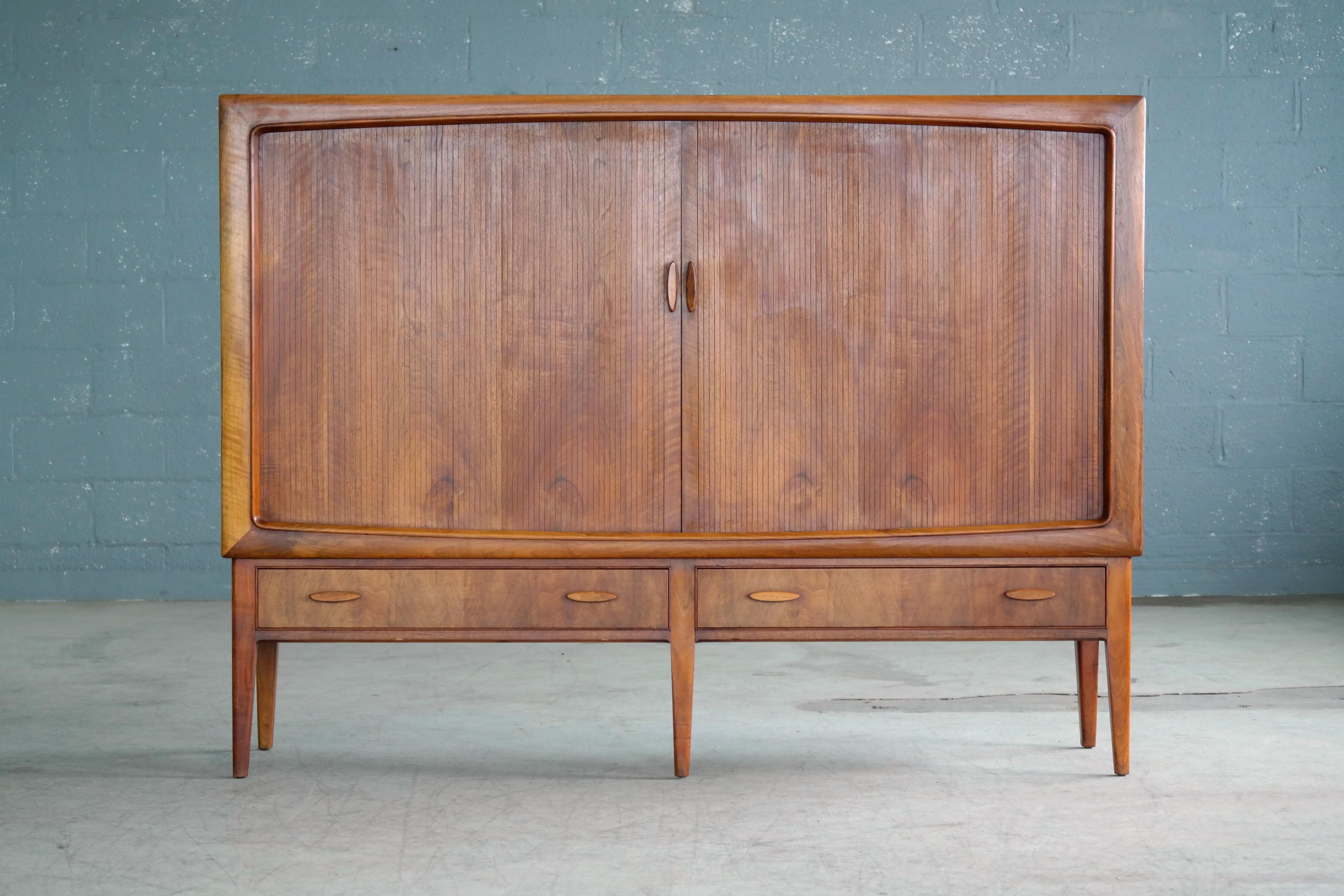 Beautiful Danish 1950s highboard in highly figured teak of great color. Elegant timeless design piece with a nice size and presence about it without being imposing. The build quality is of the highest caliber with all veneers backed by solid ply.