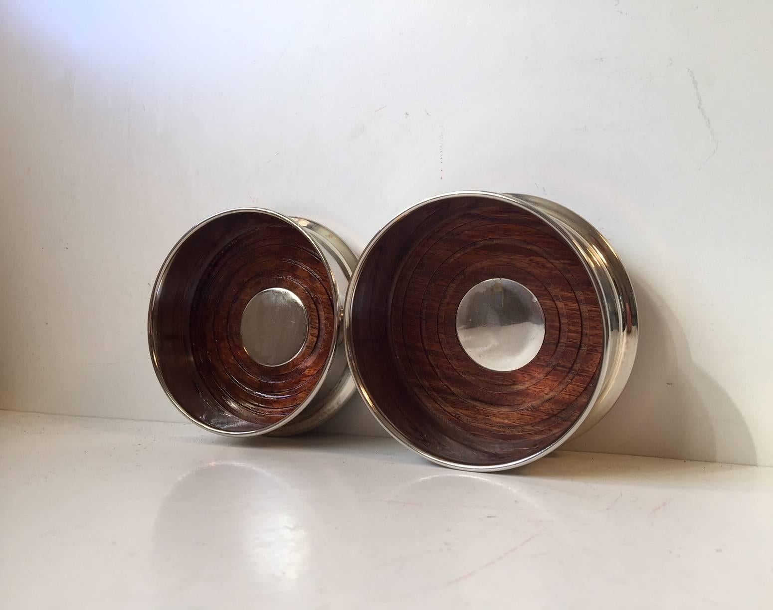 Set of coasters for champagne and wine made of silver plated brass and teak. Manufactured in Denmark during the 1950s or 1960s.