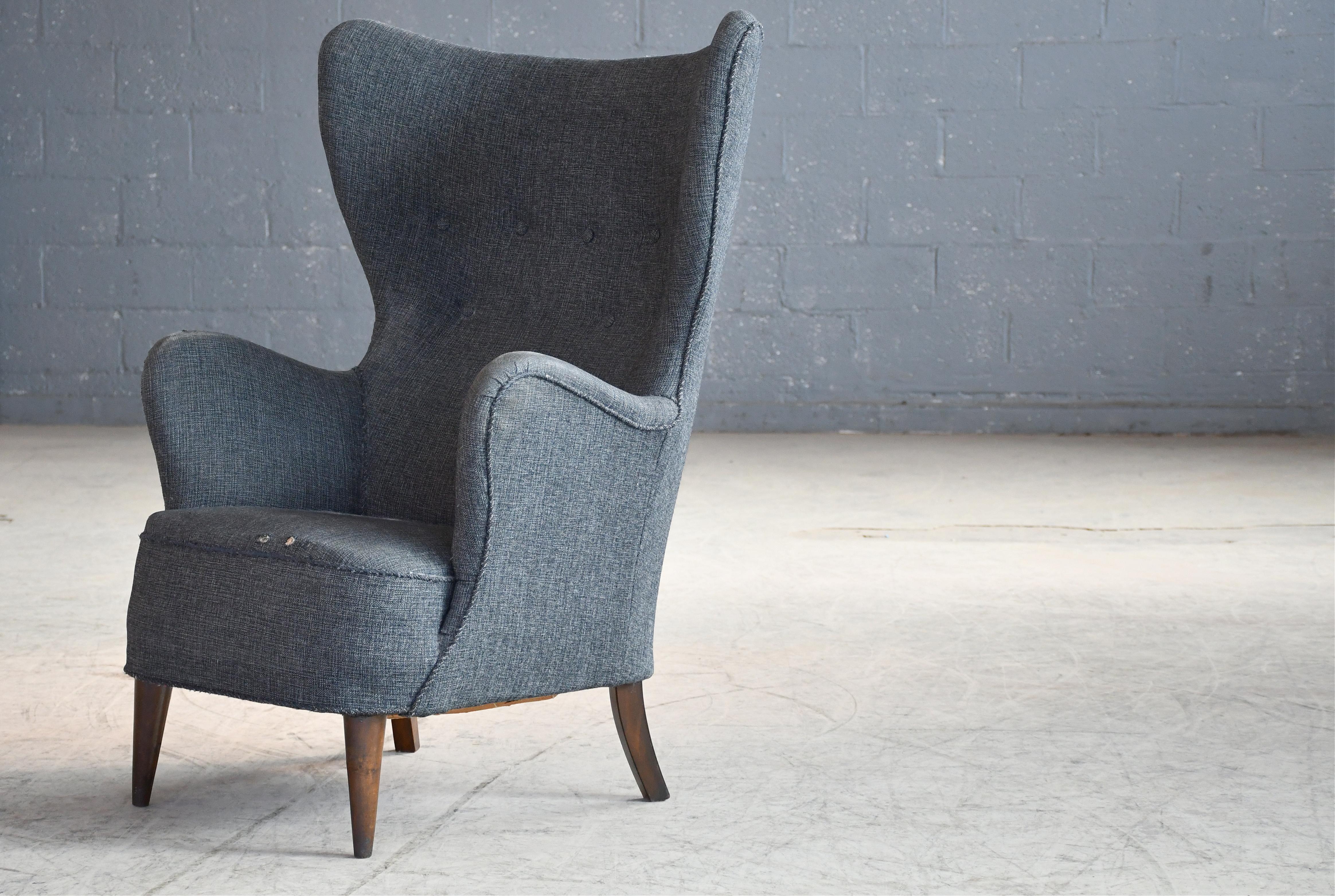 Very stylish Danish wingback lounge chair from circa 1950.  We love the organic slim profile of the design reminiscent of the styles that were to emerge in the Danish midcentury later in the decade such as the Egg chair by Arne Jacobsen. Very