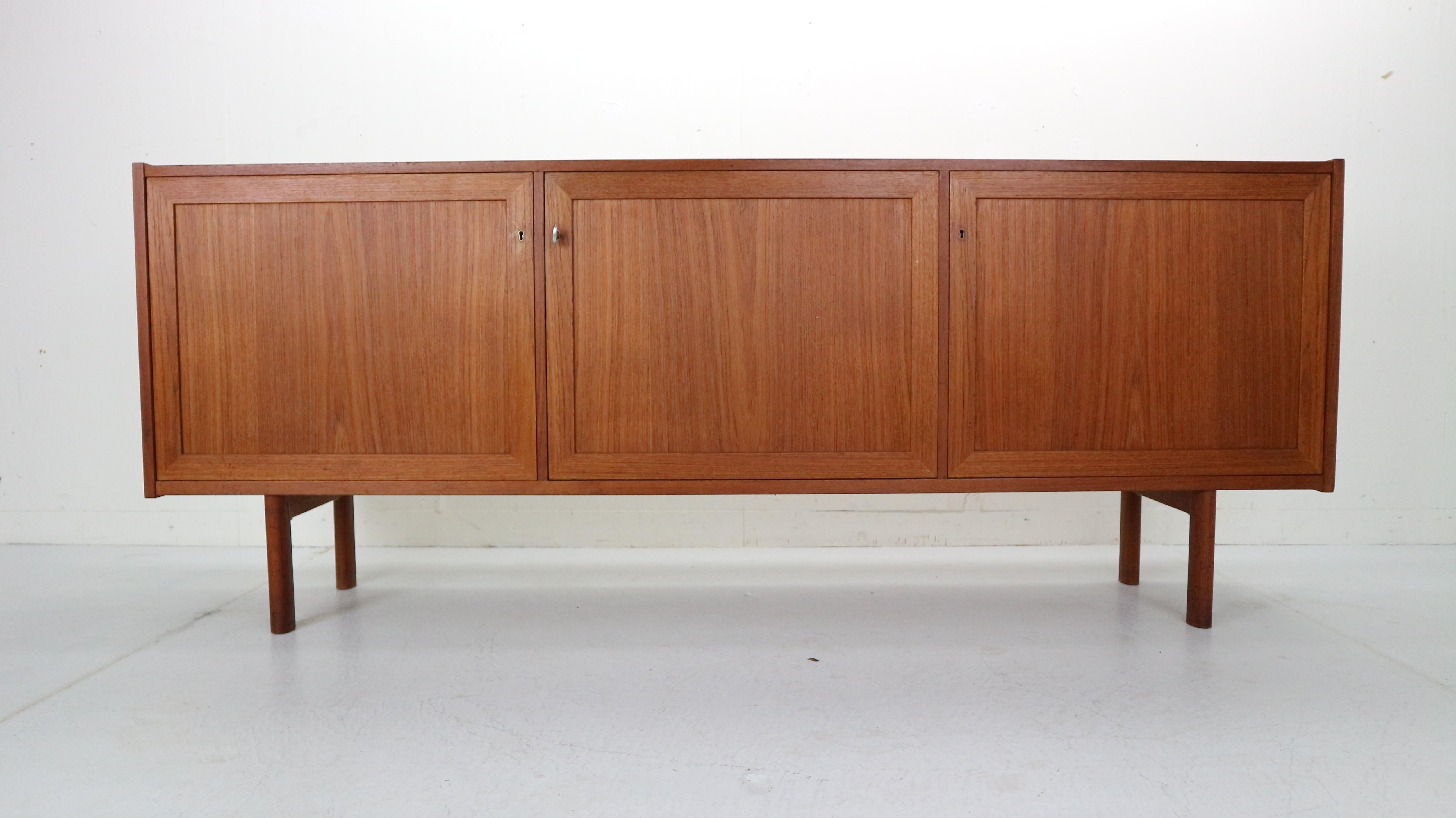 Beautifully minimalistic Danish design sideboard made in 1970s, Denmark.
It's made of teak wood and has an original key and three locks from all of the sides.
201cm long sideboard has plenty storage for your items and unique accent for your