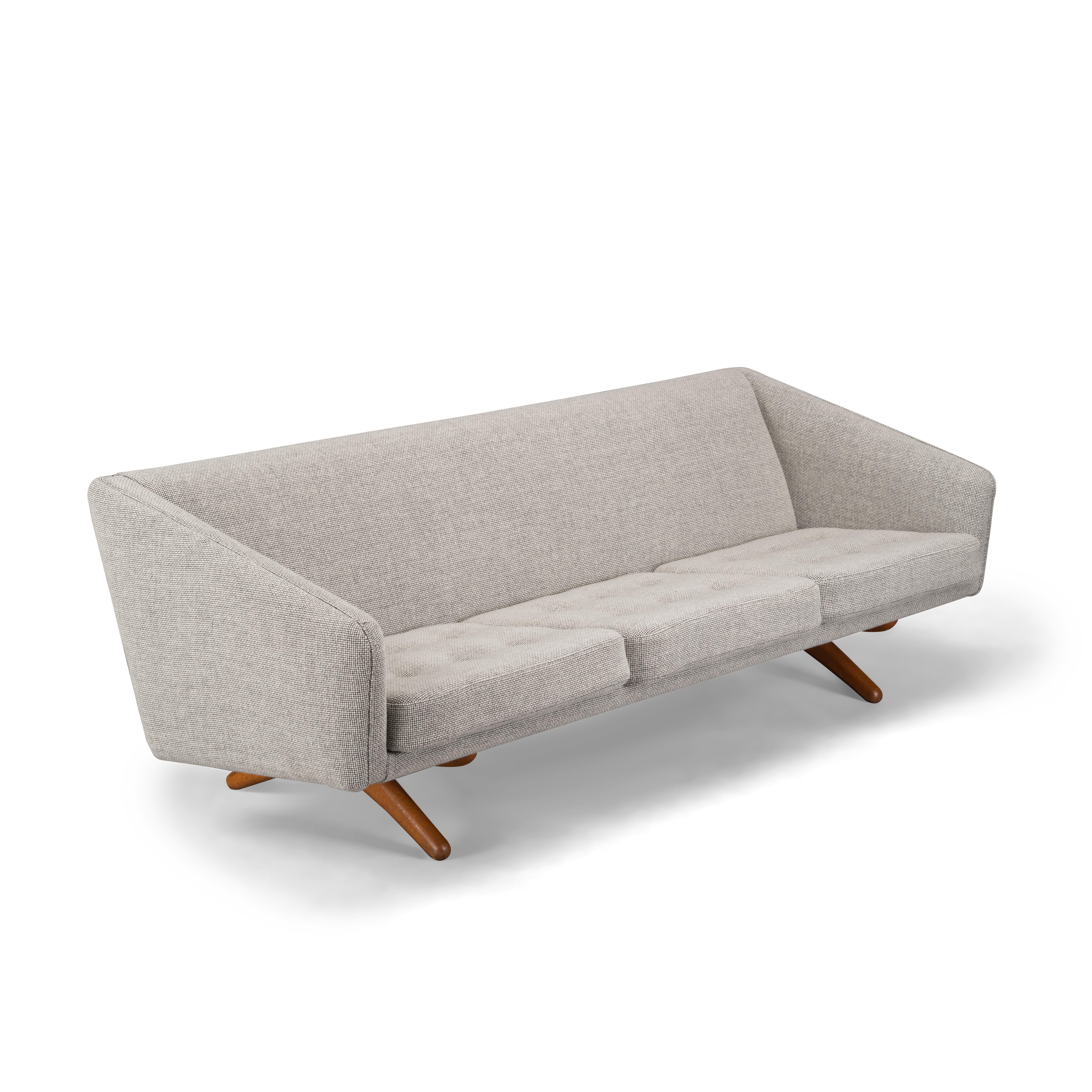 Clearly recognizable as a Illum Wikkelsø design is this comfortable ML-90 sofa. This sofa was made mid-1960s by the Michael Laursen factory. A fairly unconventional design with quadrangle side face and crossed solid teak legs that support the back