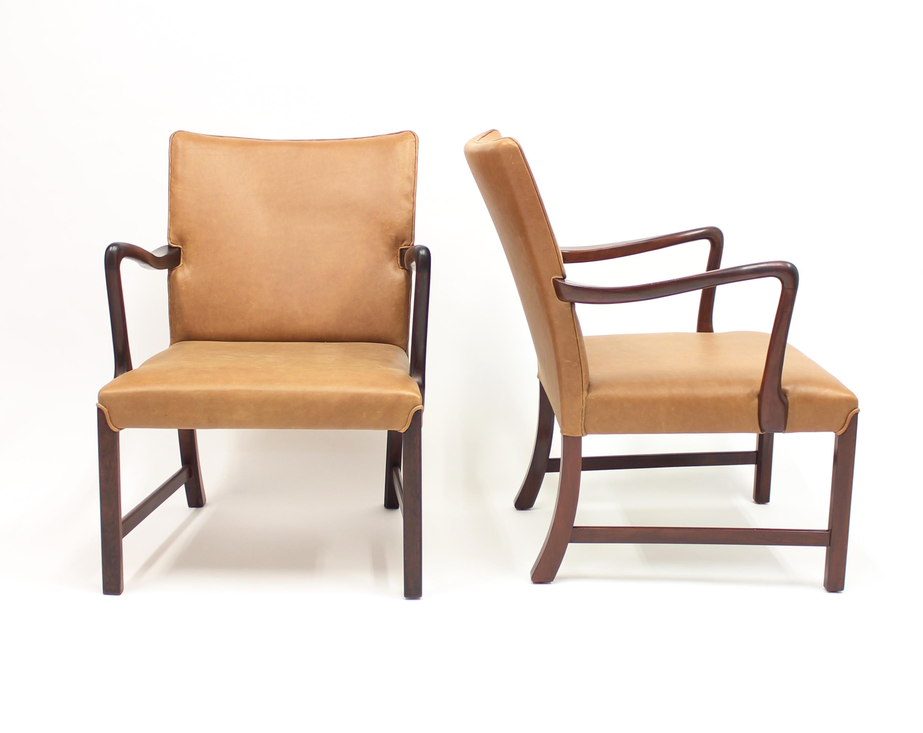 Pair of early and rare easy chairs, model 1756, designed by Ole Wanscher for Fritz Hansen in the 1940s. New vintage style leather upholstery and new stain to wooden parts. Very good vintage condition.