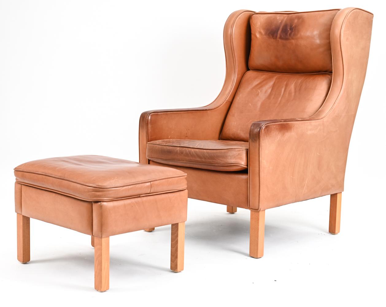 Handsome and indelibly comfortable, the Model 195 wingback chair by Mogens Hansen features an unmistakably Danish silhouette, with shelter-style wings that extend seamlessly into sloped track arms. A gently reclined back, plush removable cushions,